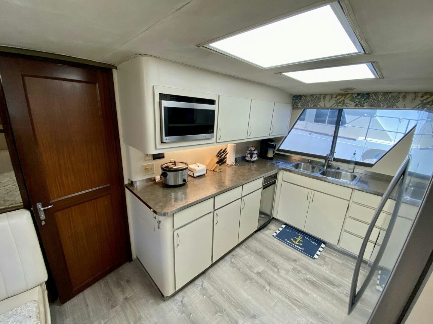 a kitchen with a microwave oven and cabinets aboard CONUNDRUM Yacht for Sale