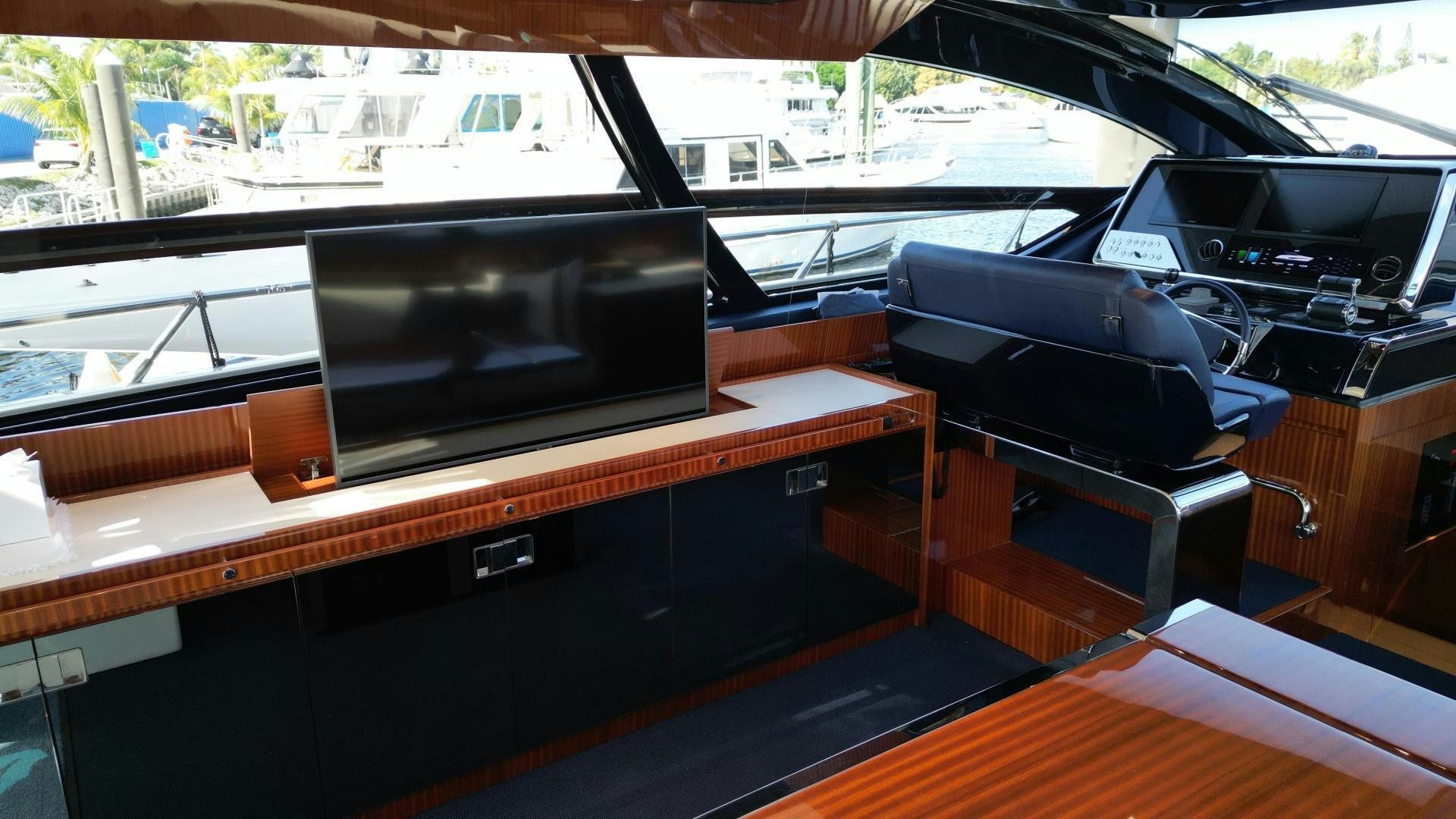 a black television on a wooden table aboard CAVALLO Yacht for Sale
