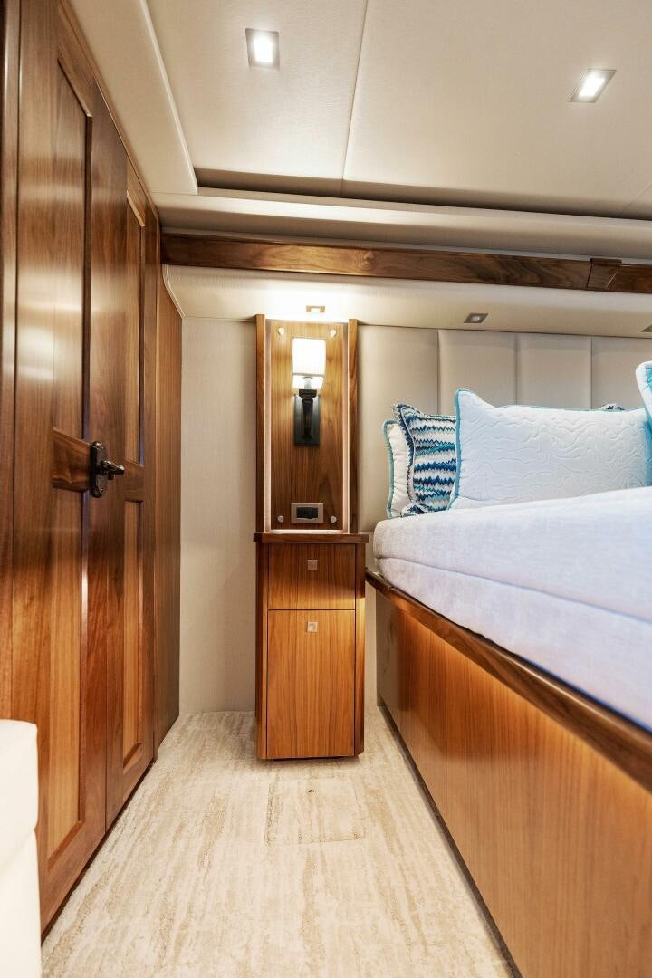 a bedroom with a bed and a closet aboard SHOE  Yacht for Sale