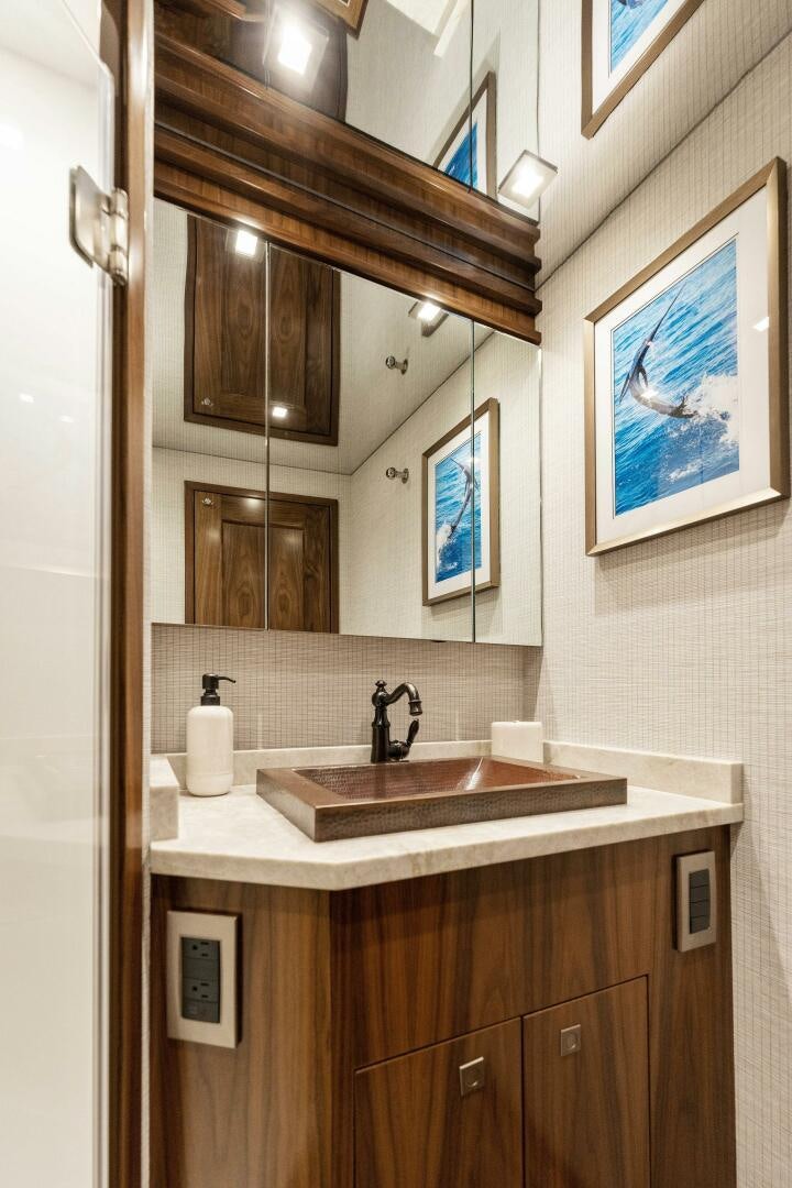 a bathroom with a sink and a mirror aboard SHOE  Yacht for Sale