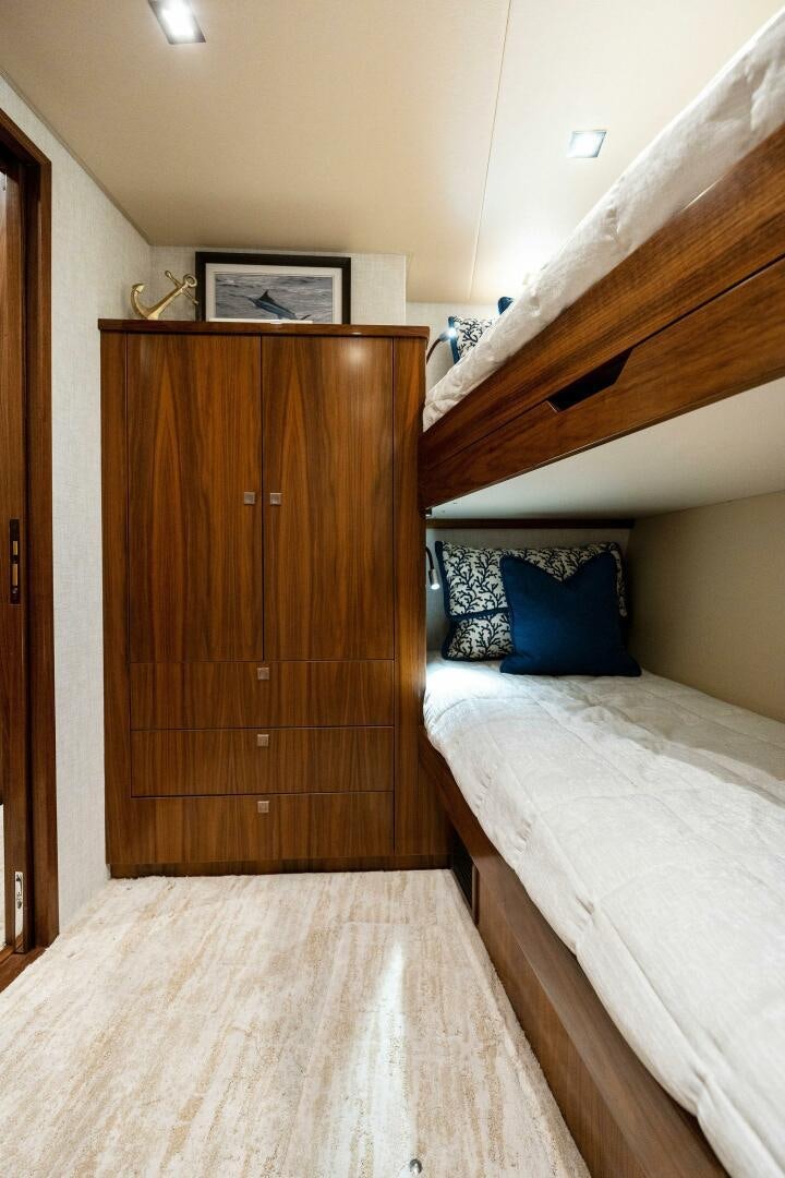 a bedroom with a wood cabinet aboard SHOE  Yacht for Sale