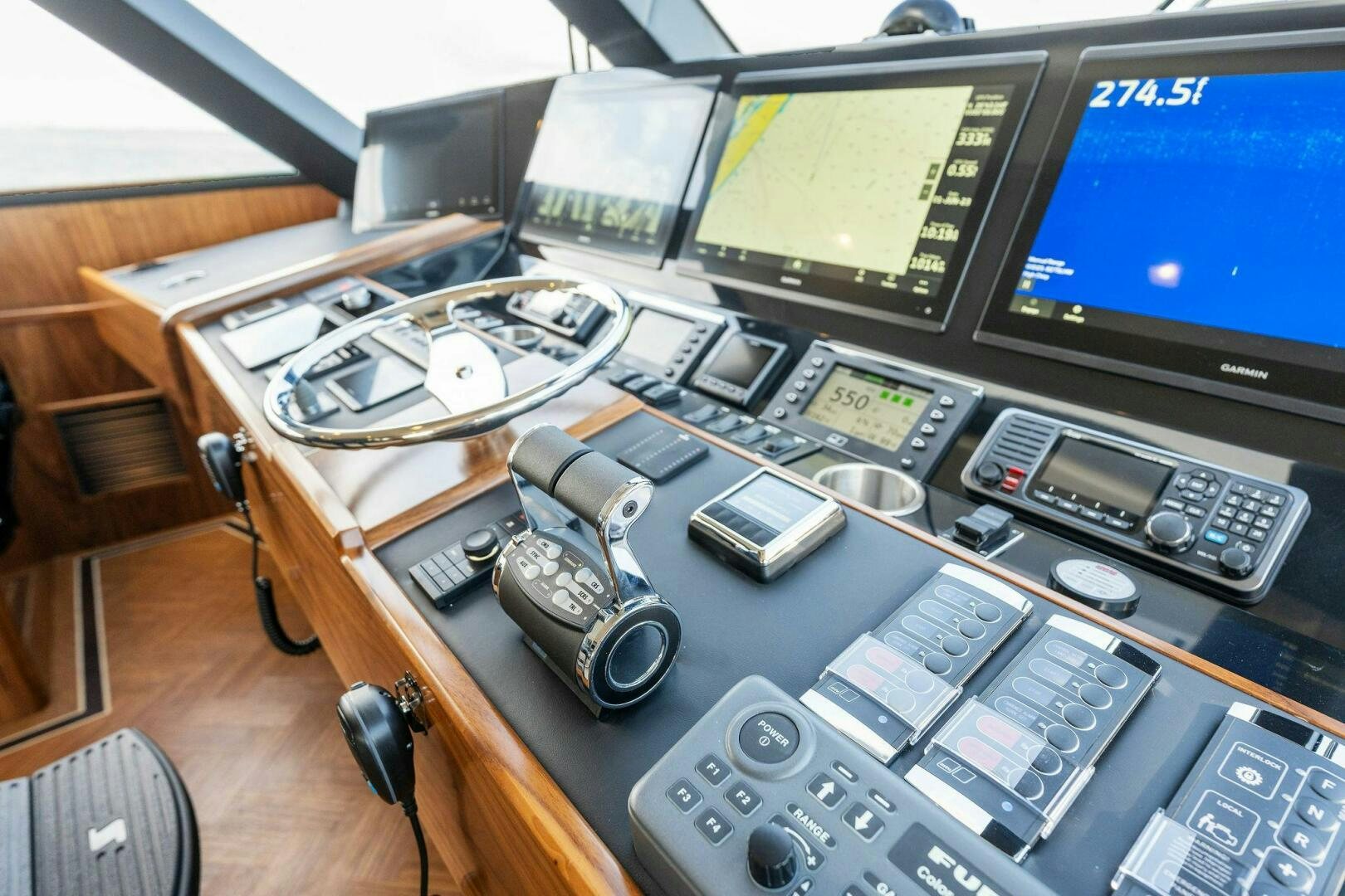 a desk with a computer and a couple of phones on it aboard SHOE  Yacht for Sale