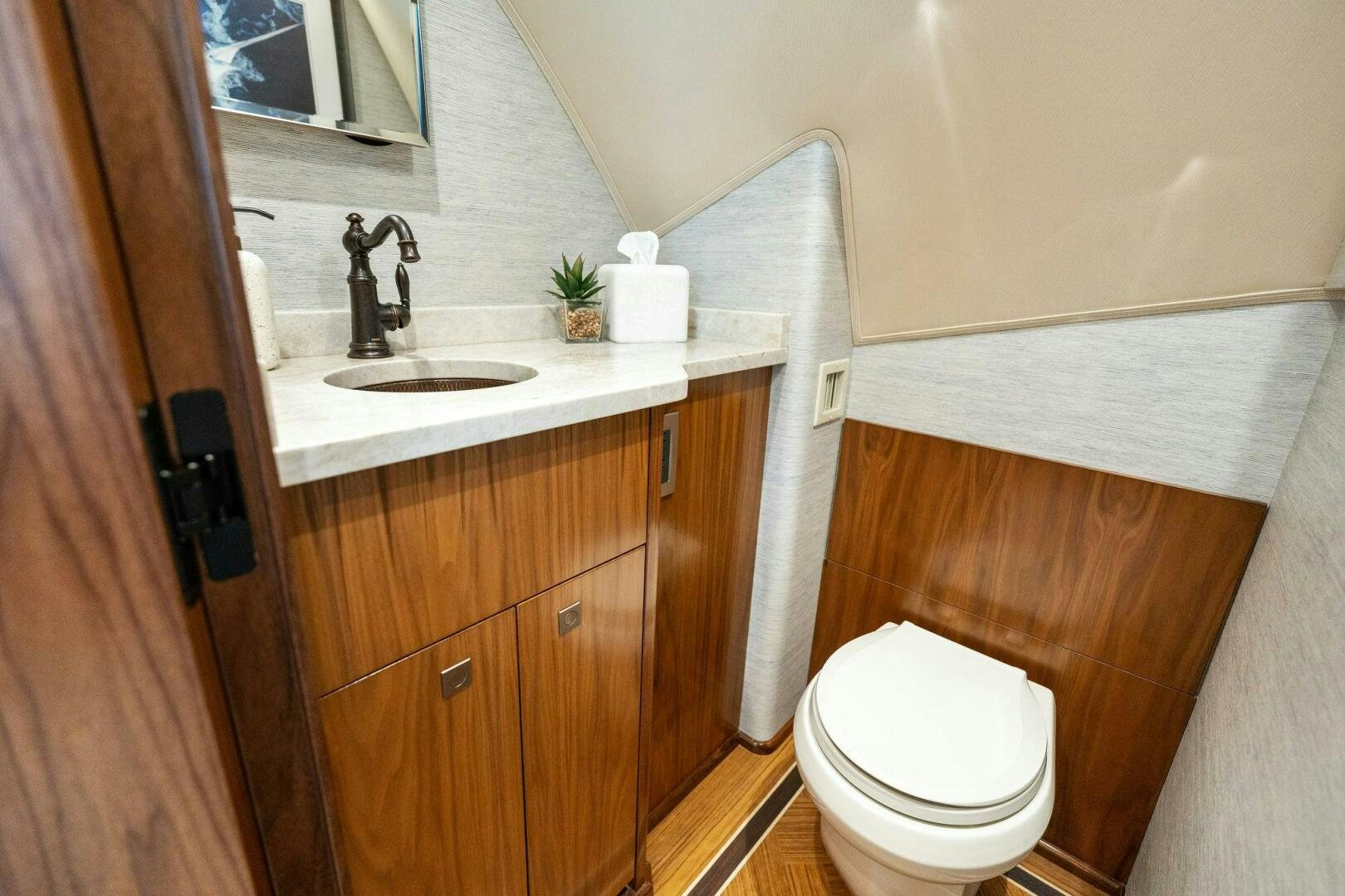 a bathroom with a toilet sink and a mirror aboard SHOE  Yacht for Sale