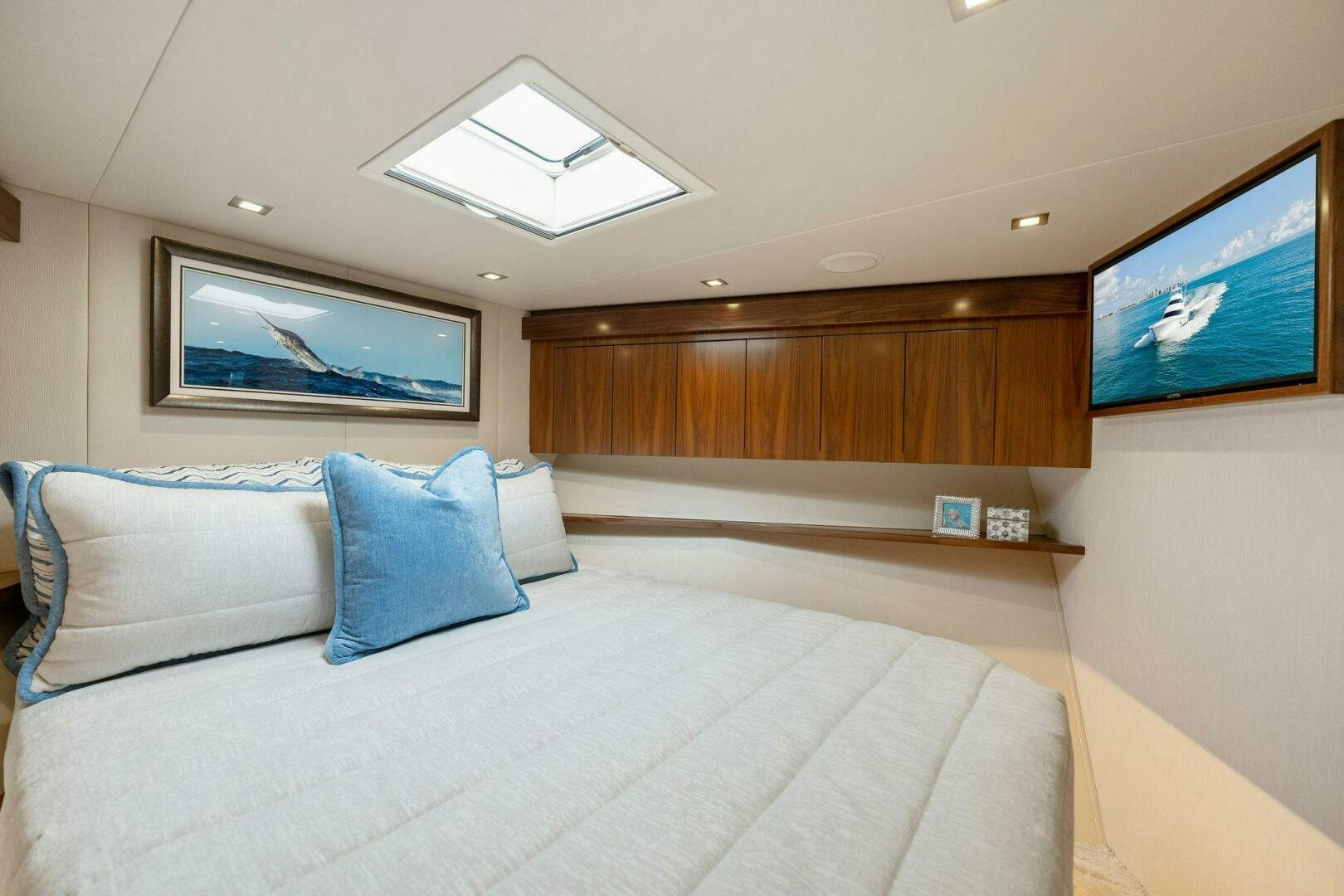 a bed with a white bed and a television on the wall aboard SHOE  Yacht for Sale