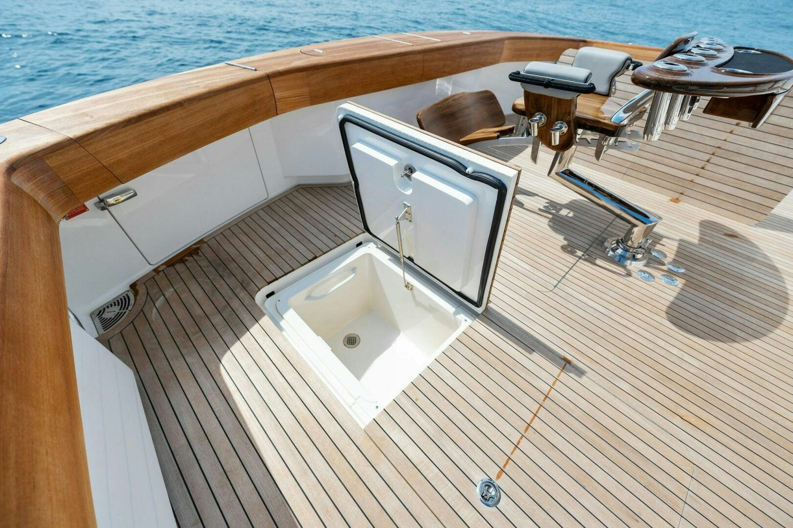 a white rectangular object on a wooden surface next to a wooden table aboard SHOE  Yacht for Sale