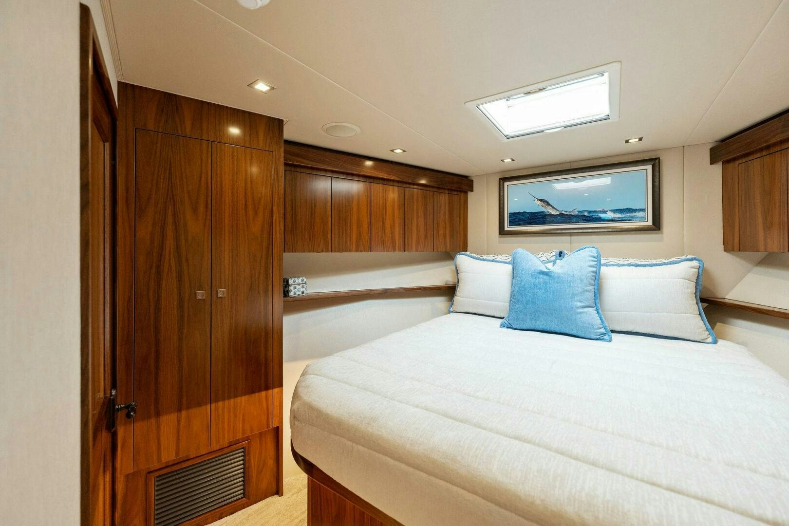 a room with a bed and a wood cabinet aboard SHOE  Yacht for Sale