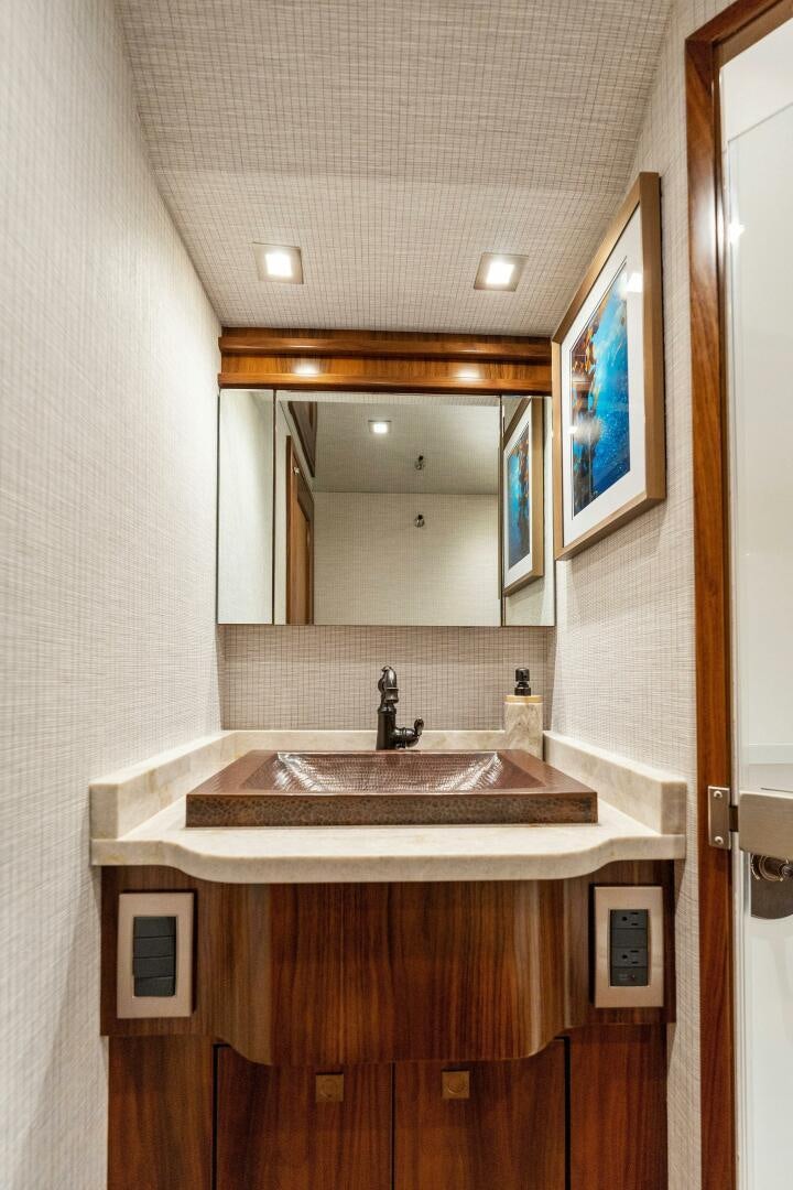 a bathroom with a sink and a mirror aboard SHOE  Yacht for Sale