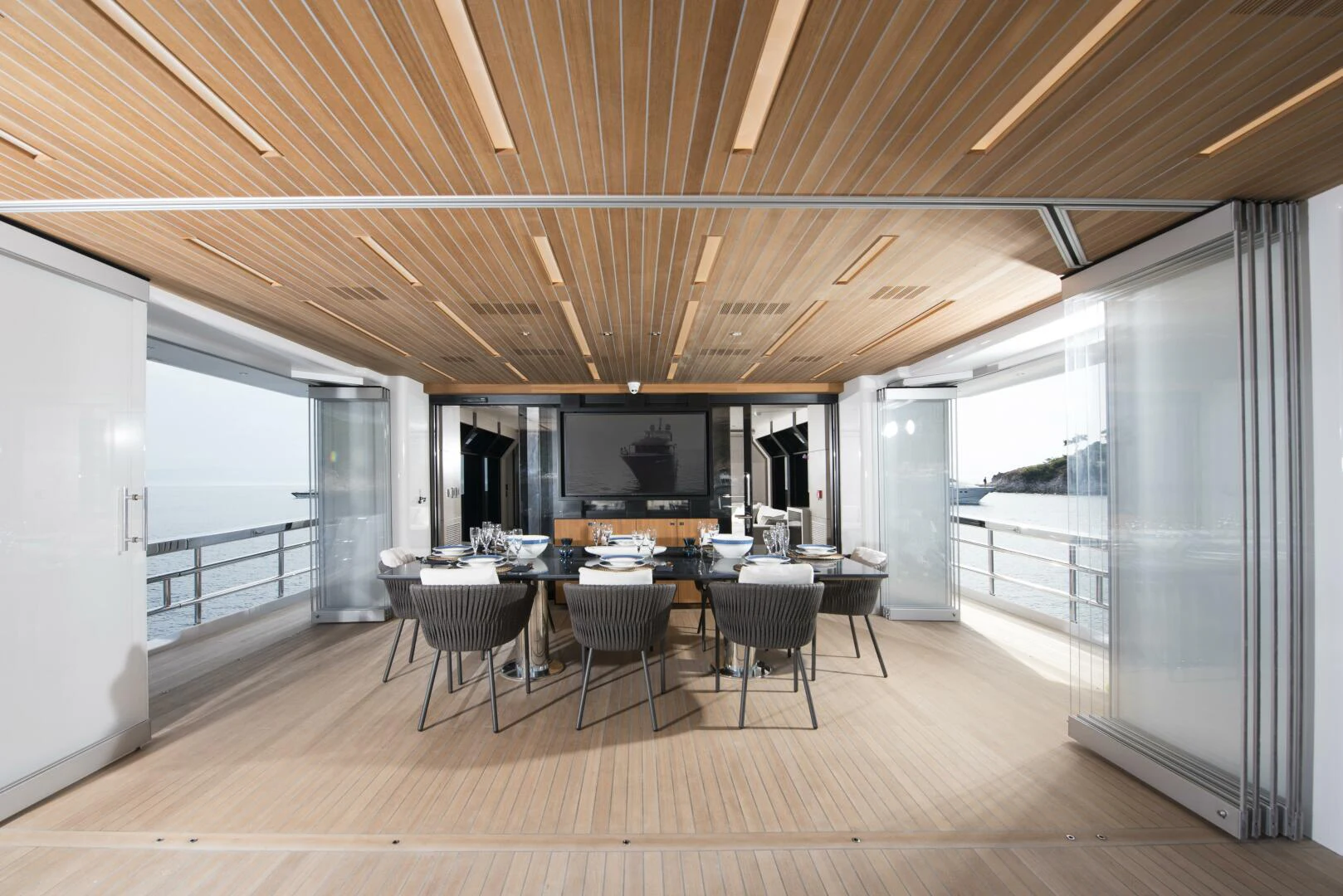 a room with a table and chairs aboard PICCOLO Yacht for Sale