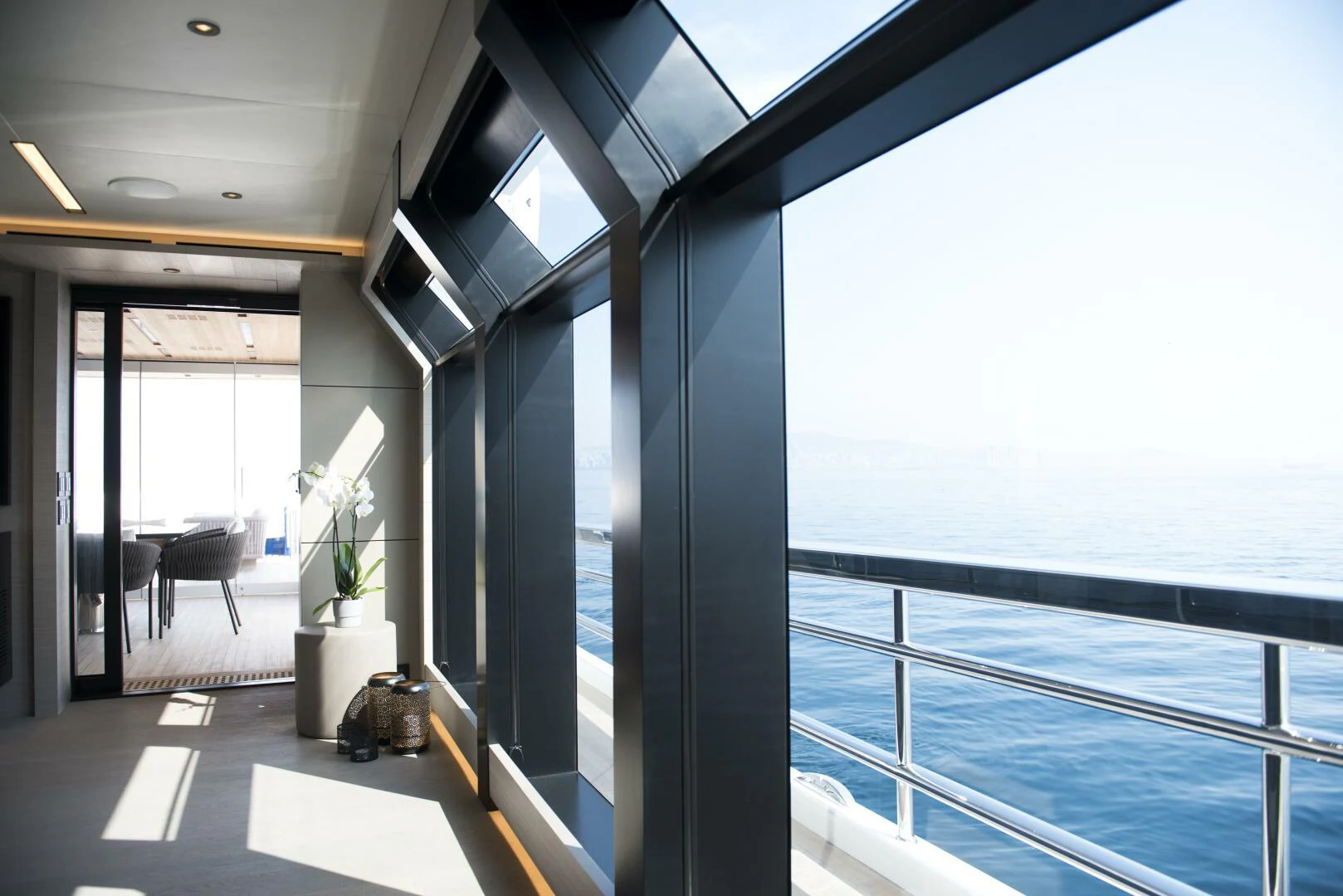 a room with a large window and a table and chairs aboard PICCOLO Yacht for Sale