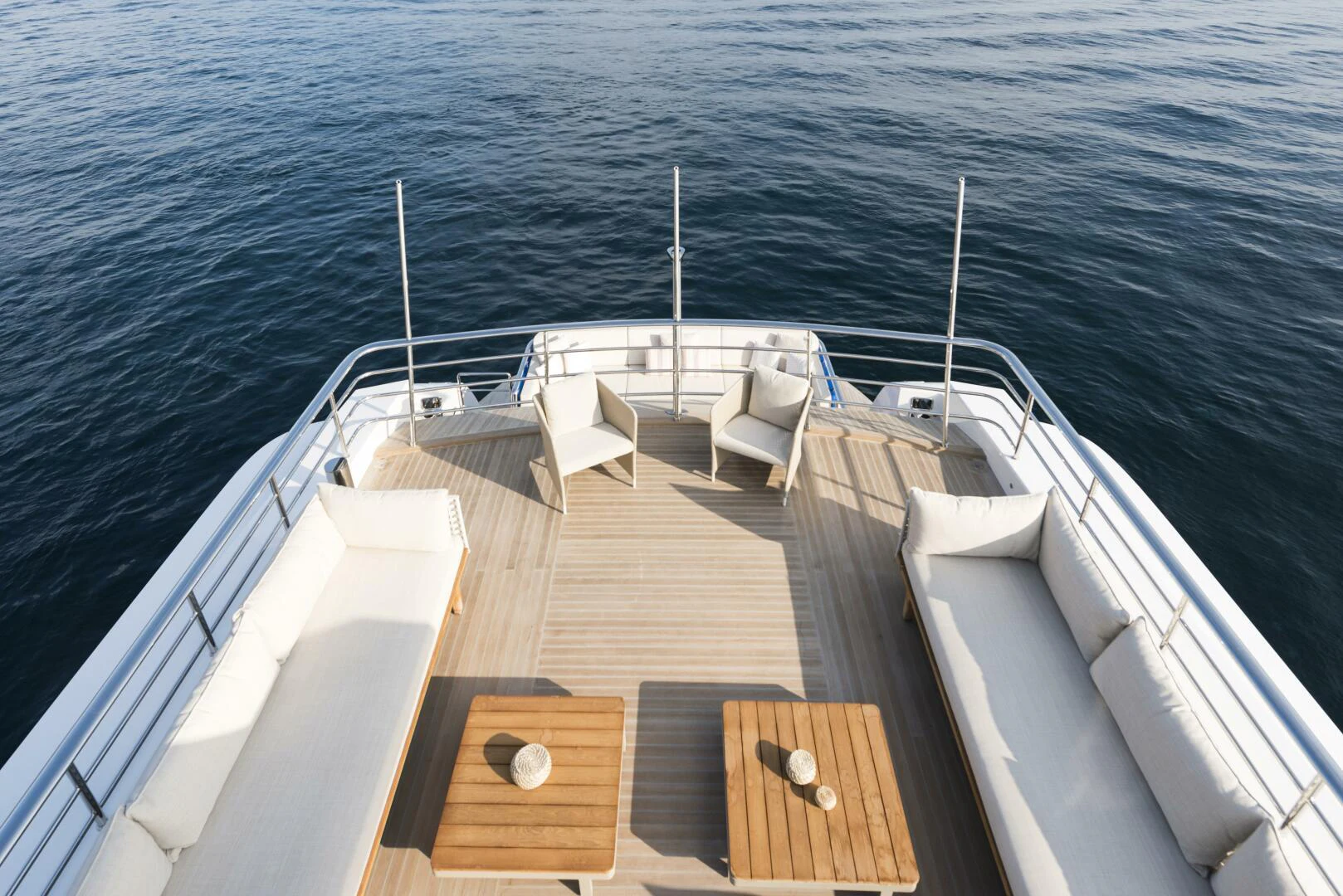 a deck with chairs on it and a body of water in the background aboard PICCOLO Yacht for Sale
