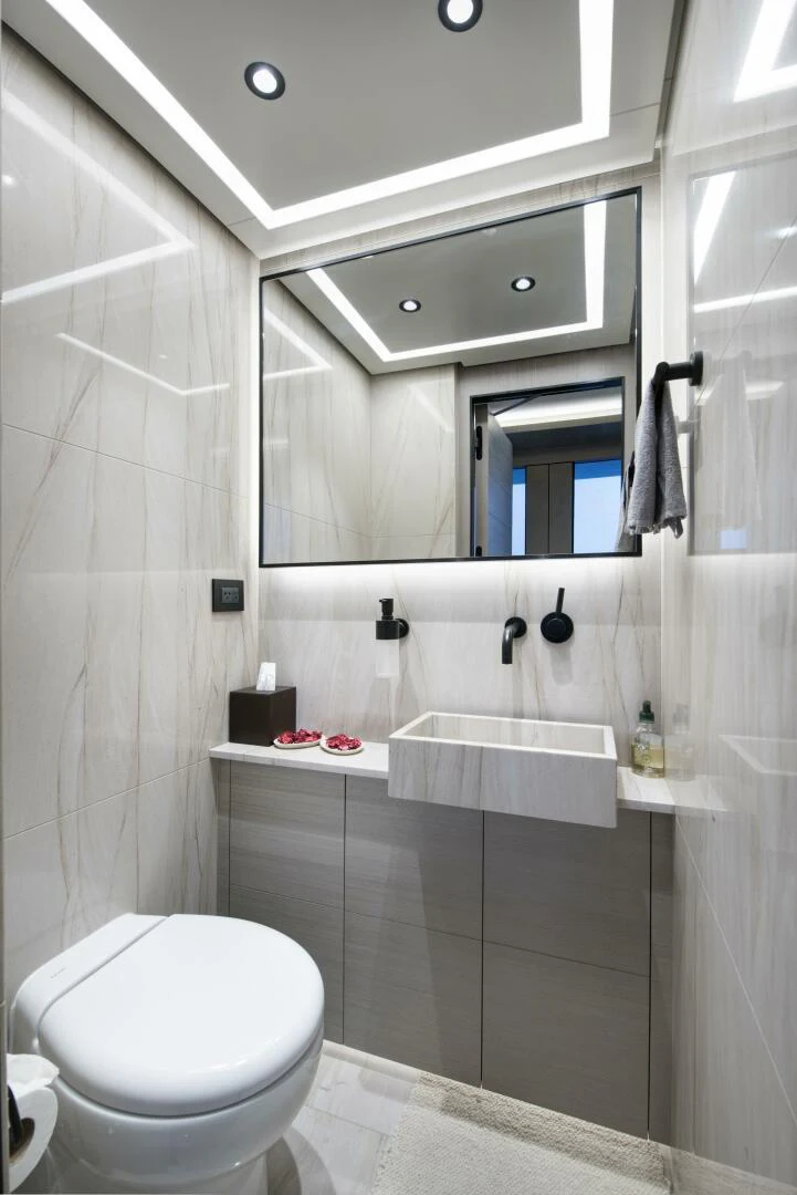 a bathroom with a tub sink and toilet aboard PICCOLO Yacht for Sale