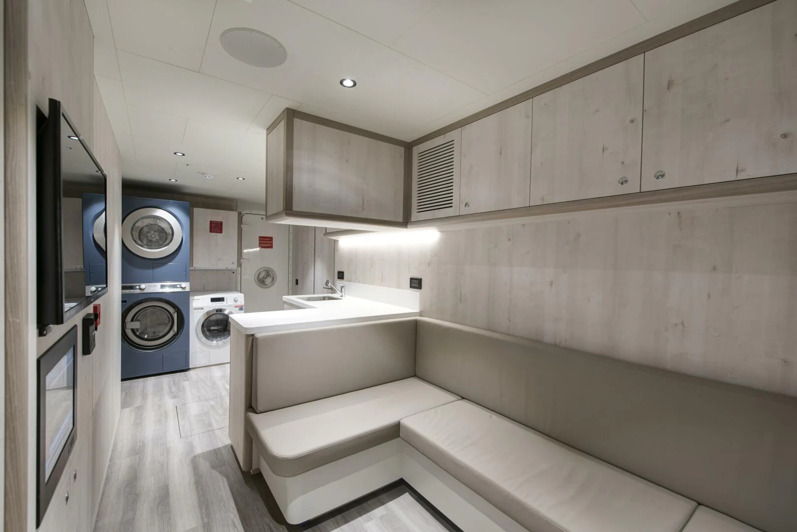a room with a washing machine and a sink aboard PICCOLO Yacht for Sale