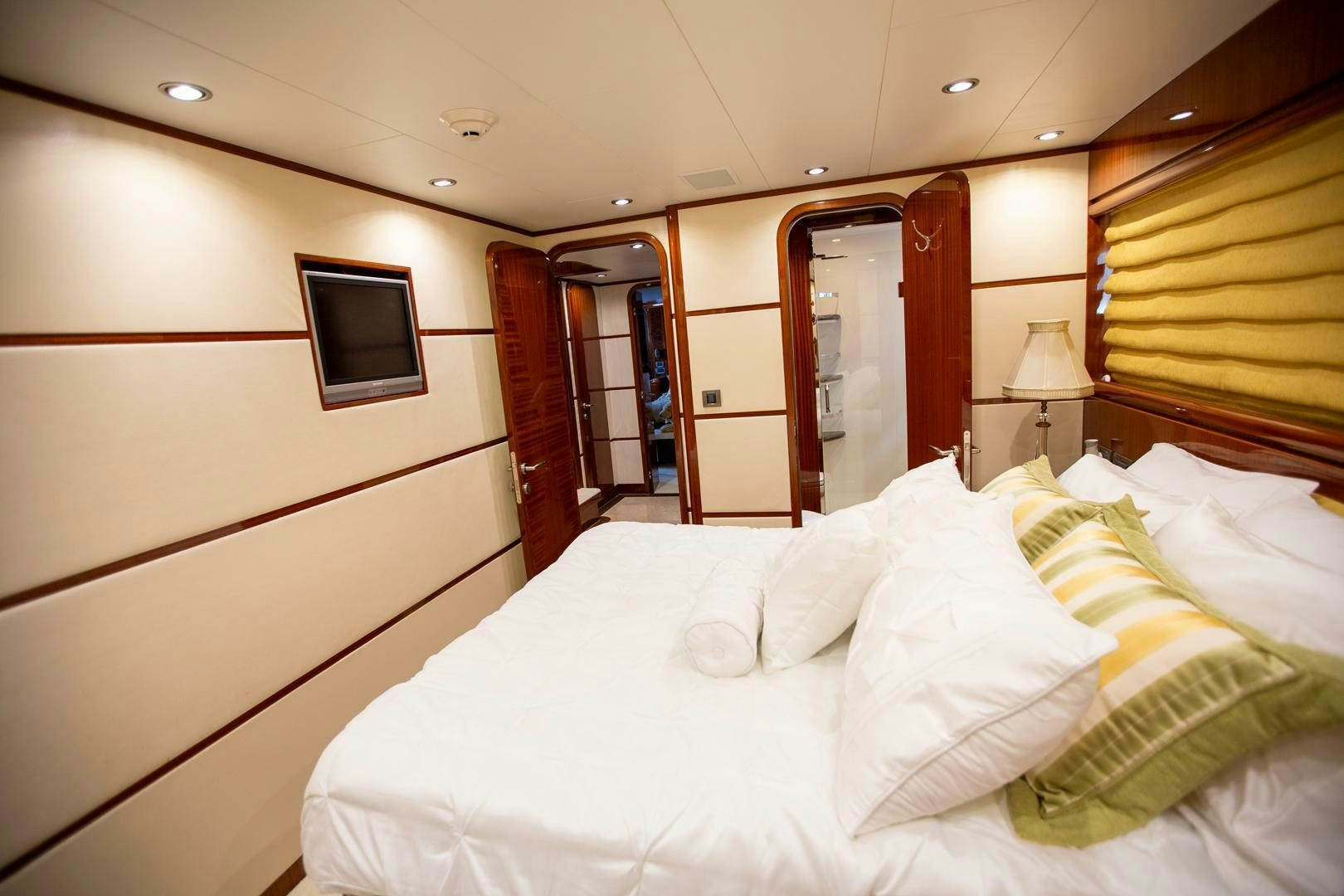 a room with a bed and a television aboard AMERICAN HONEY Yacht for Sale