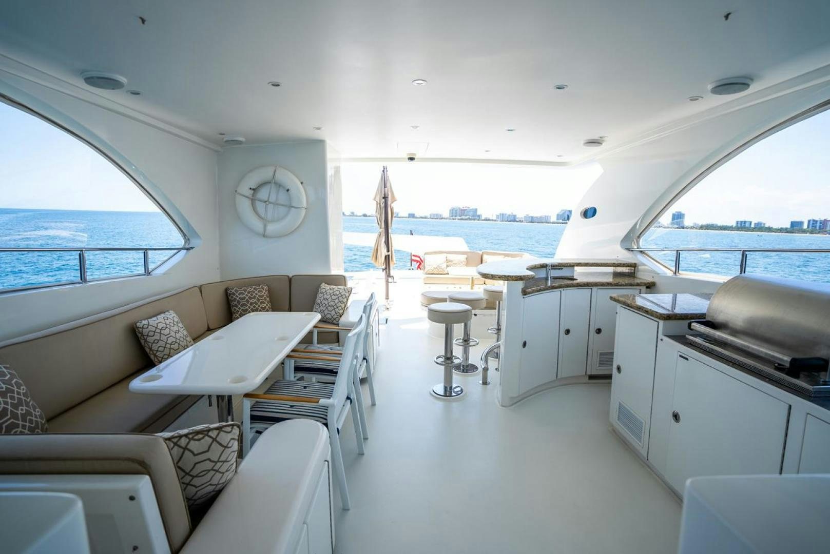 a room with a couch and a table and chairs aboard AMERICAN HONEY Yacht for Sale