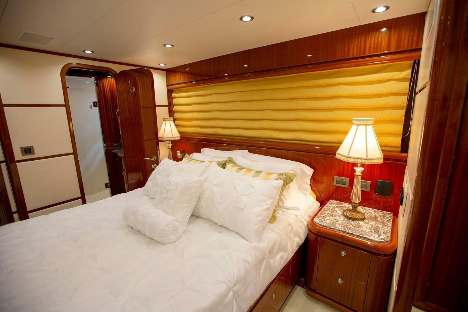 a bed with white sheets aboard AMERICAN HONEY Yacht for Sale