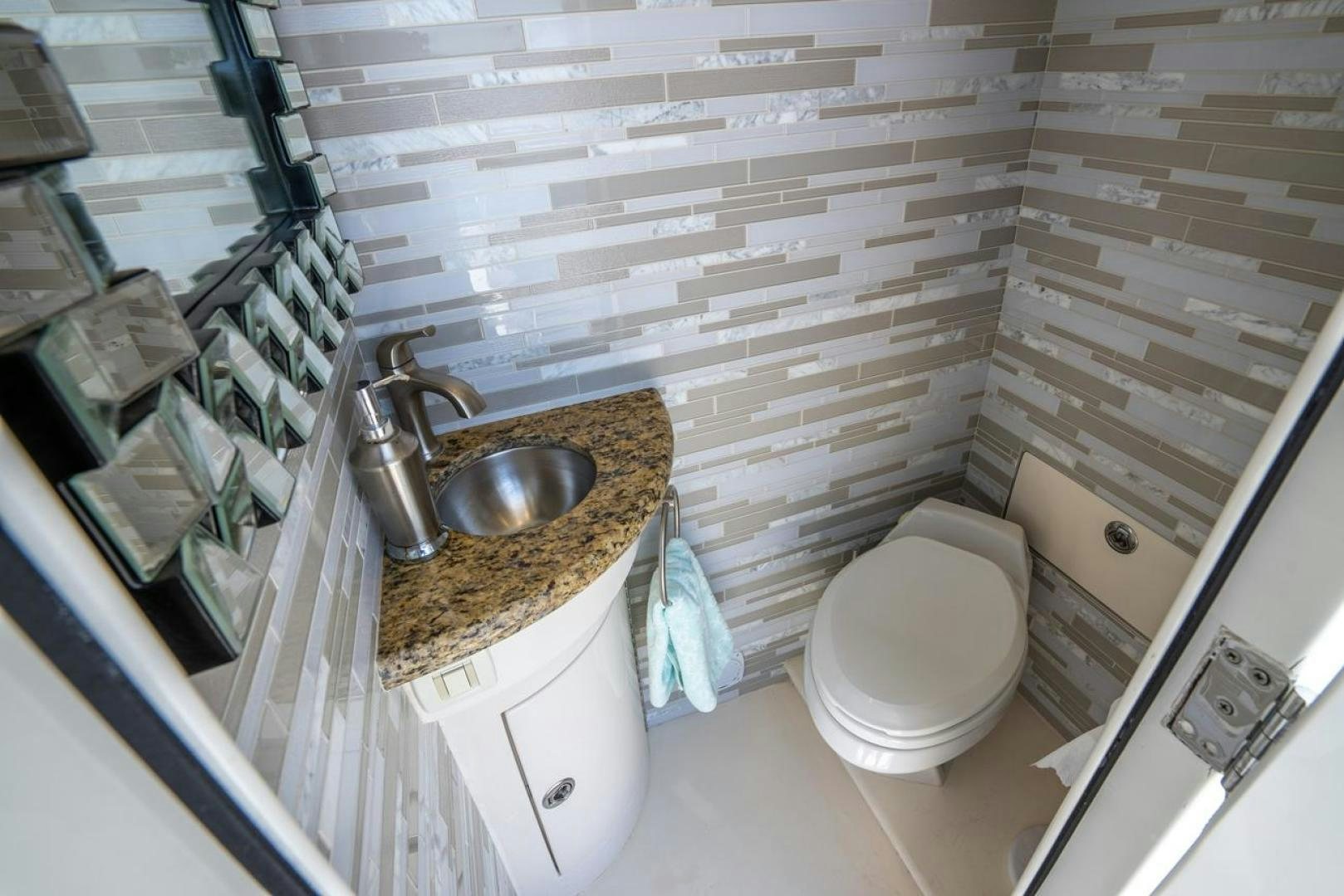a bathroom with a sink and toilet aboard AMERICAN HONEY Yacht for Sale