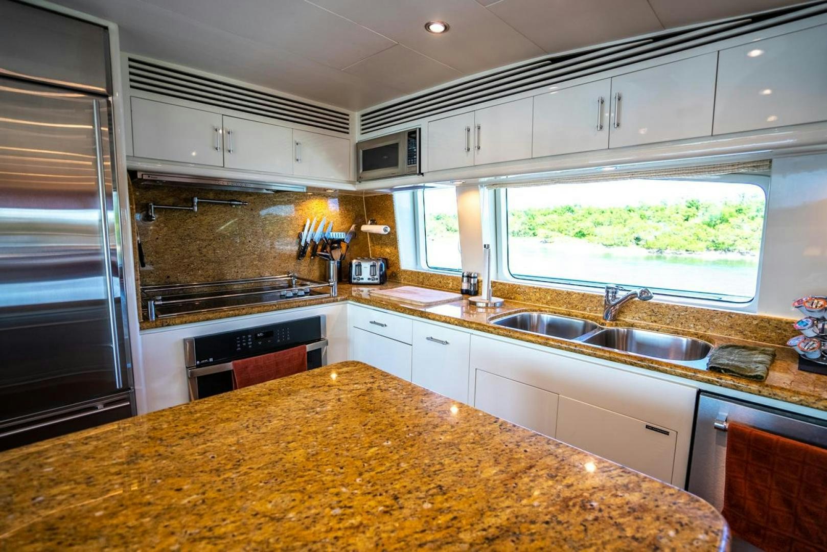 a kitchen with white cabinets aboard AMERICAN HONEY Yacht for Sale