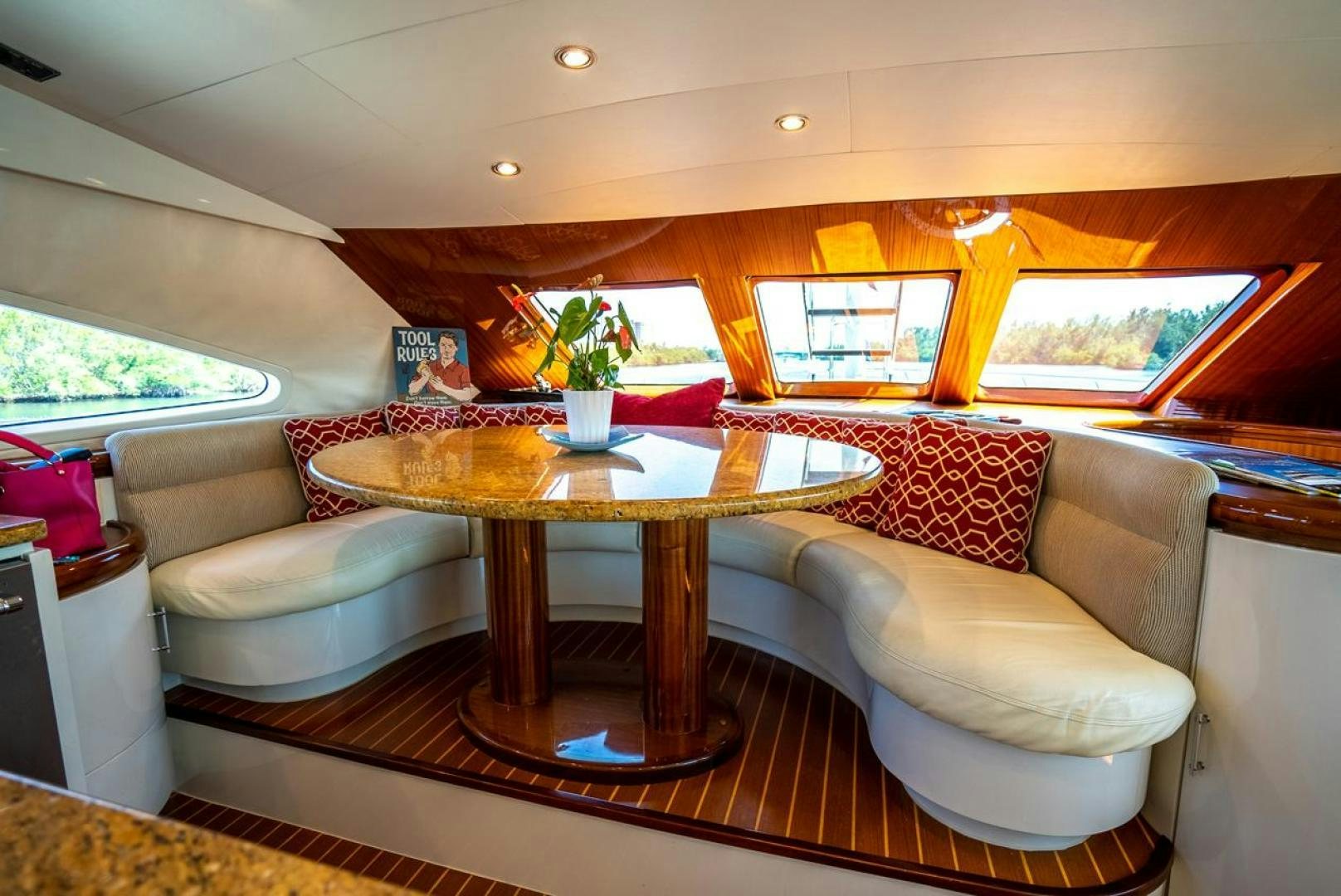 a living room with a table and couches aboard AMERICAN HONEY Yacht for Sale