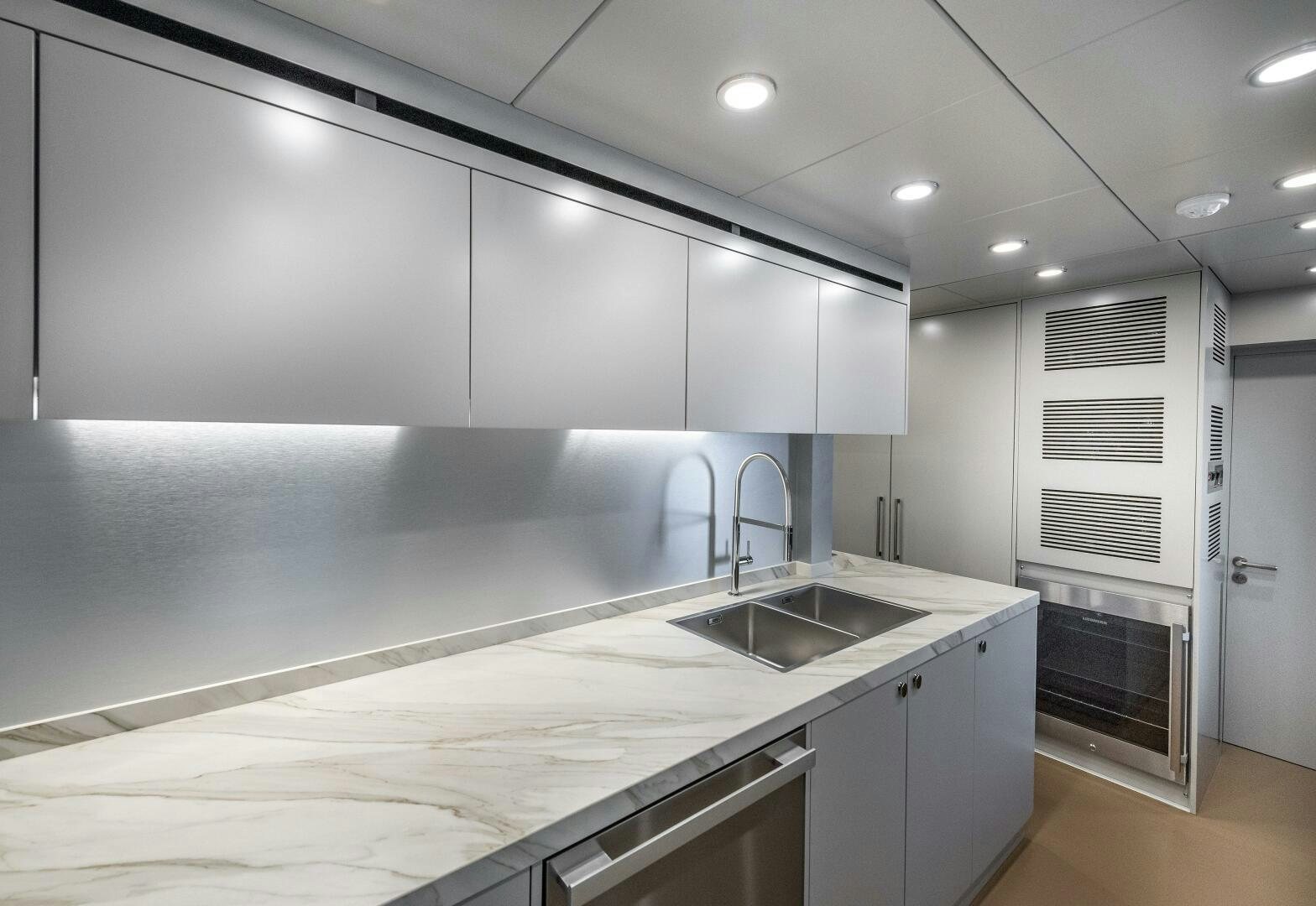 a kitchen with white cabinets aboard 37XP 08 ROCKIT Yacht for Sale
