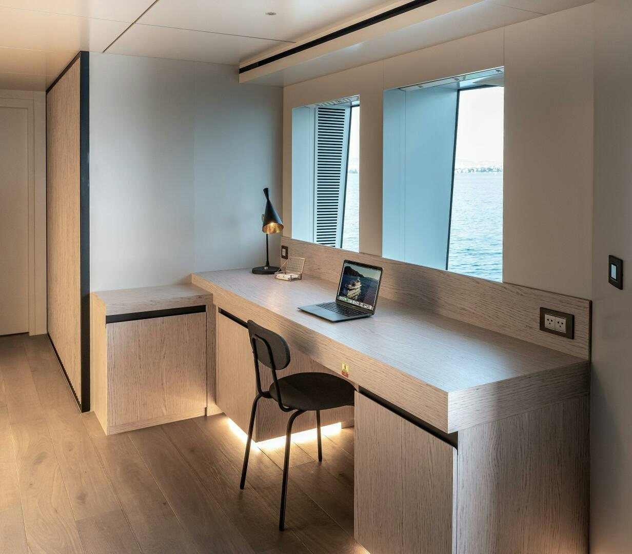 a desk with a laptop on it aboard 37XP 08 ROCKIT Yacht for Sale