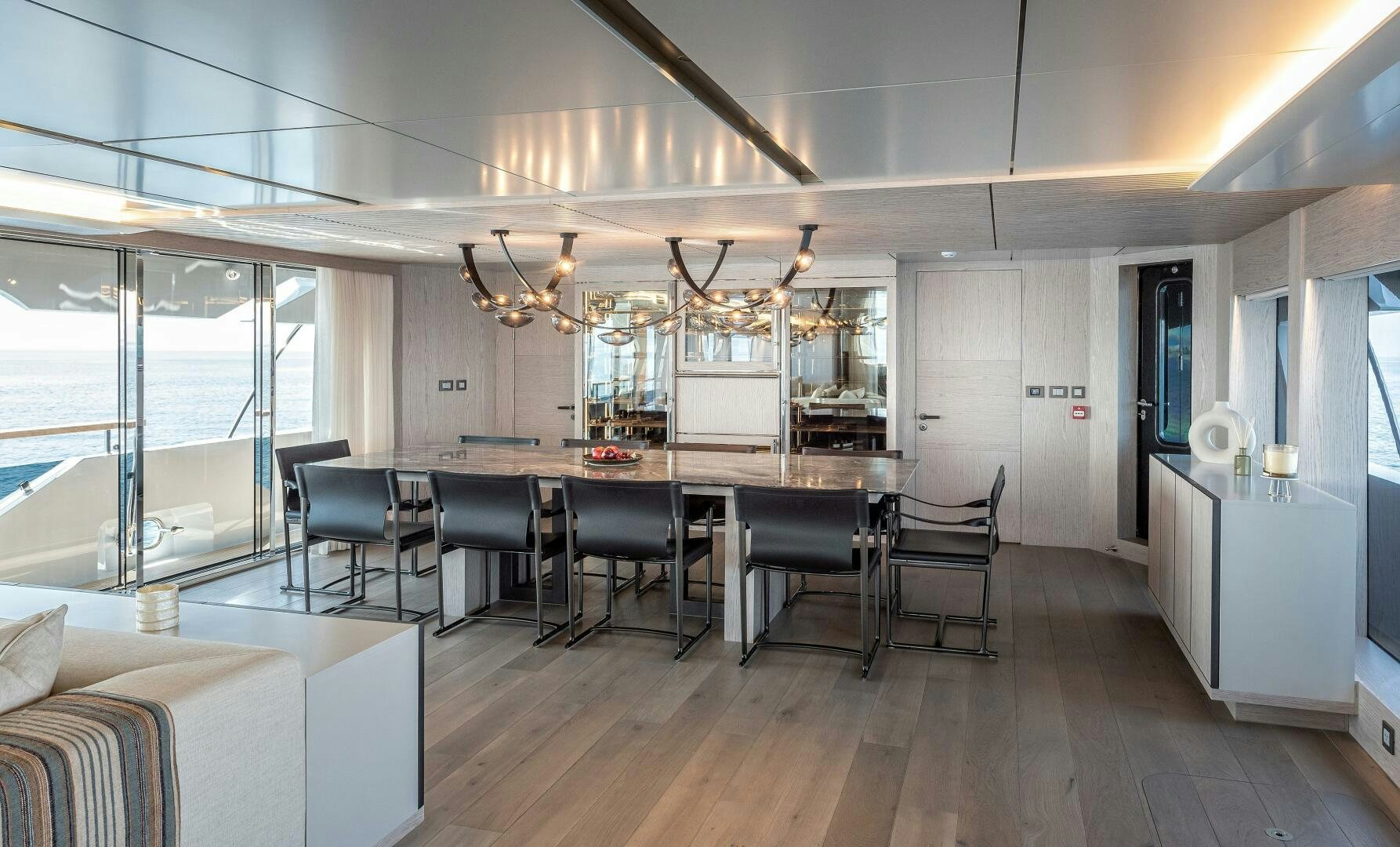 a large room with a table and chairs aboard 37XP 08 ROCKIT Yacht for Sale