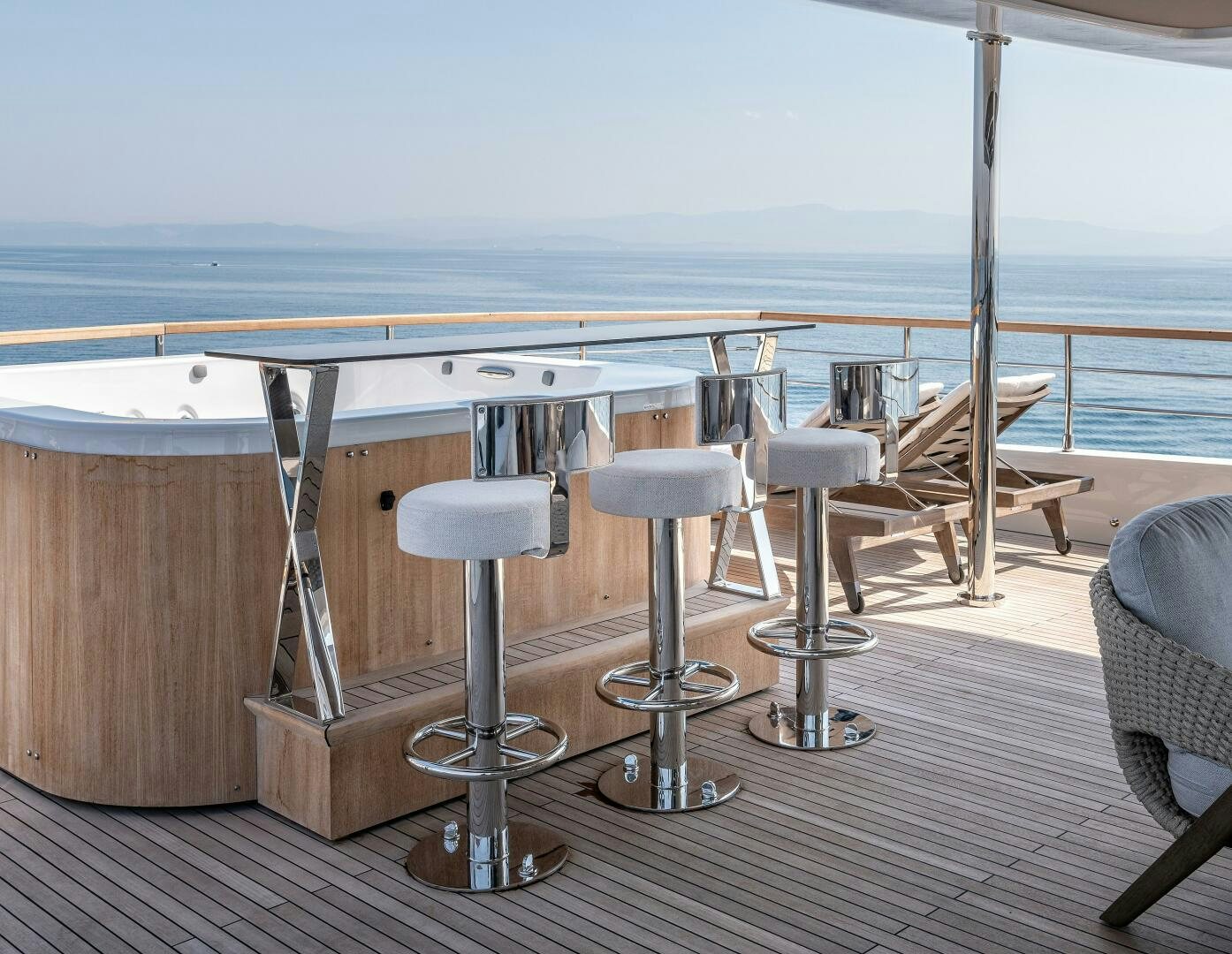 a room with a table chairs and a large body of water aboard 37XP 08 ROCKIT Yacht for Sale