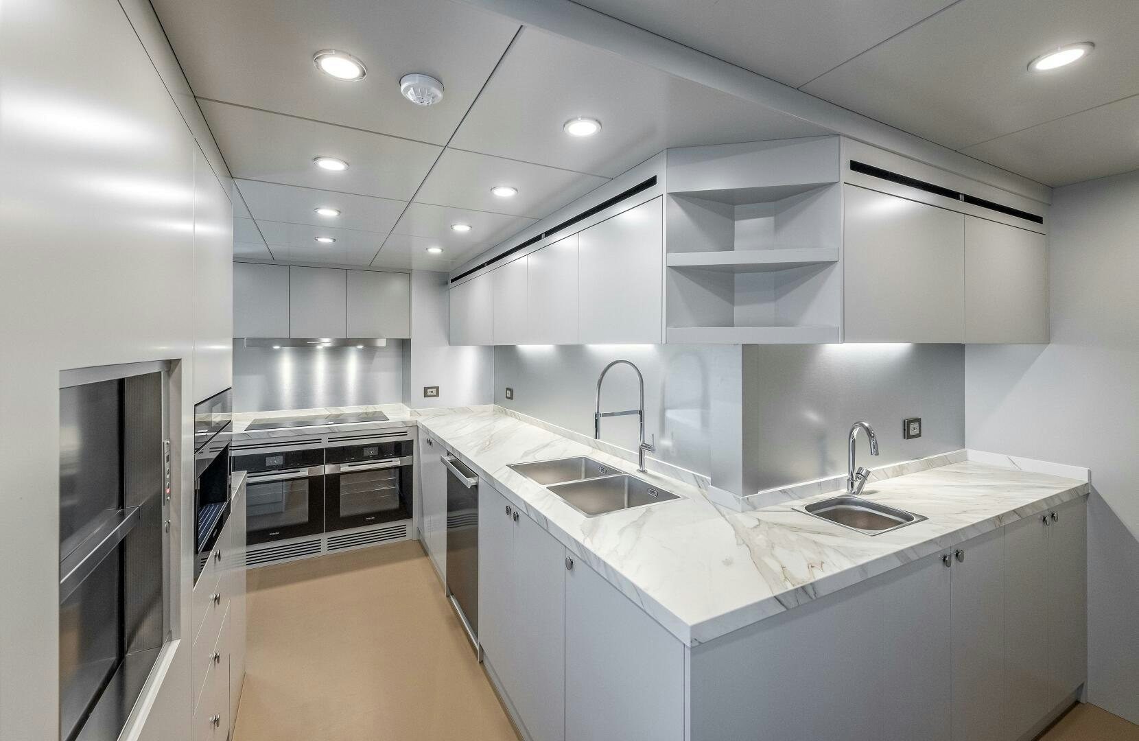 a kitchen with white cabinets aboard 37XP 08 ROCKIT Yacht for Sale