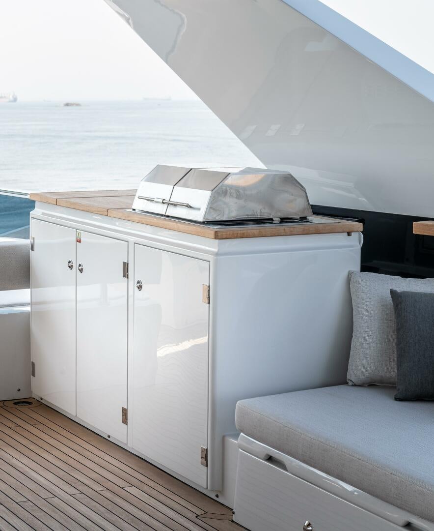 a white couch and a white cabinet aboard 37XP 08 ROCKIT Yacht for Sale