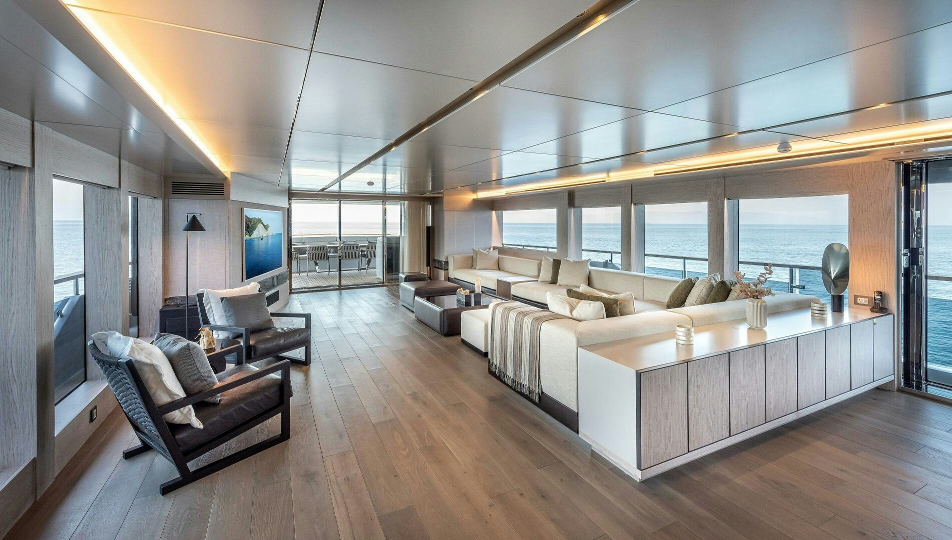 a large living room with a large white couch and a wood floor aboard 37XP 08 ROCKIT Yacht for Sale