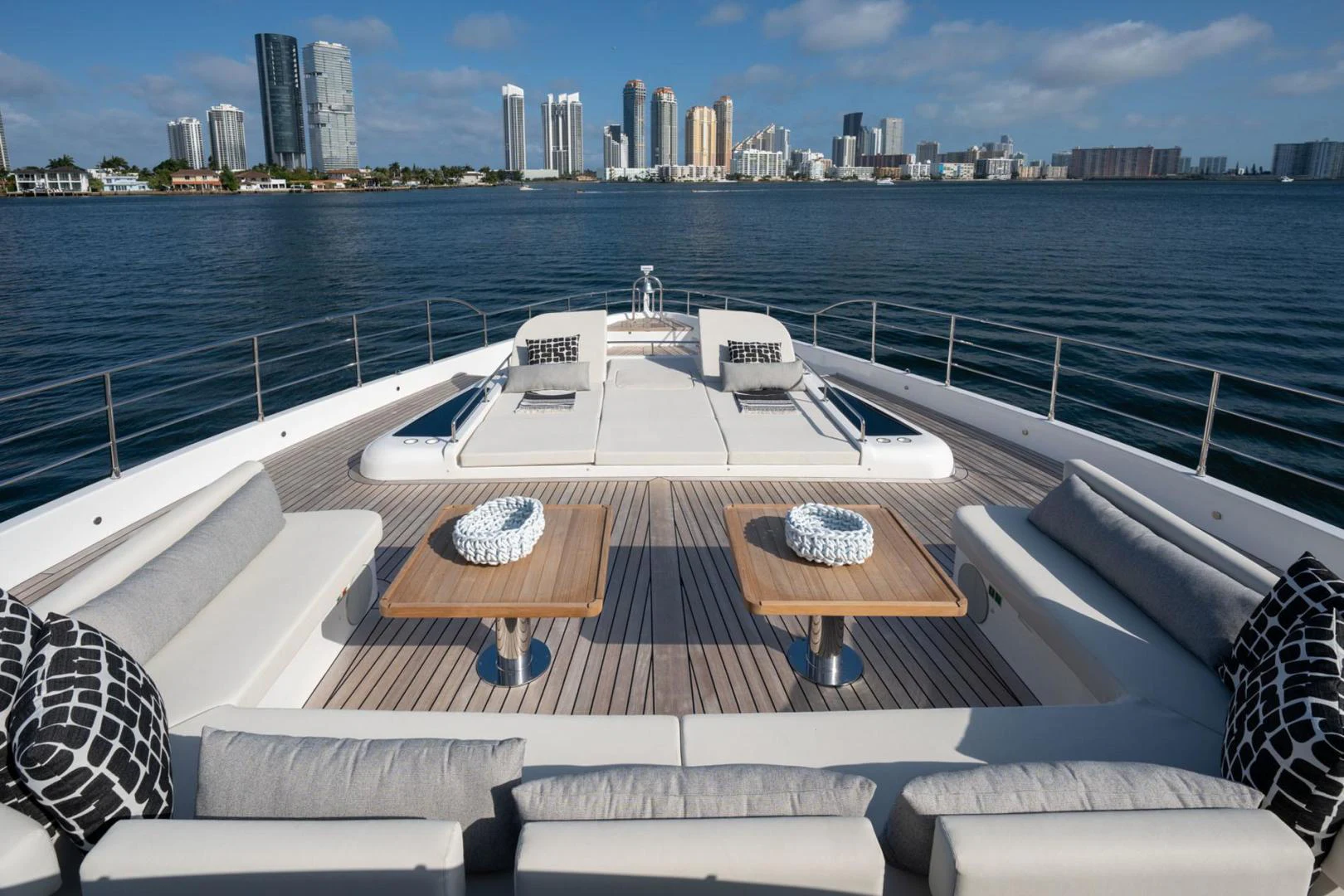 a deck with a view of a city and a body of water aboard SANTOSH Yacht for Sale