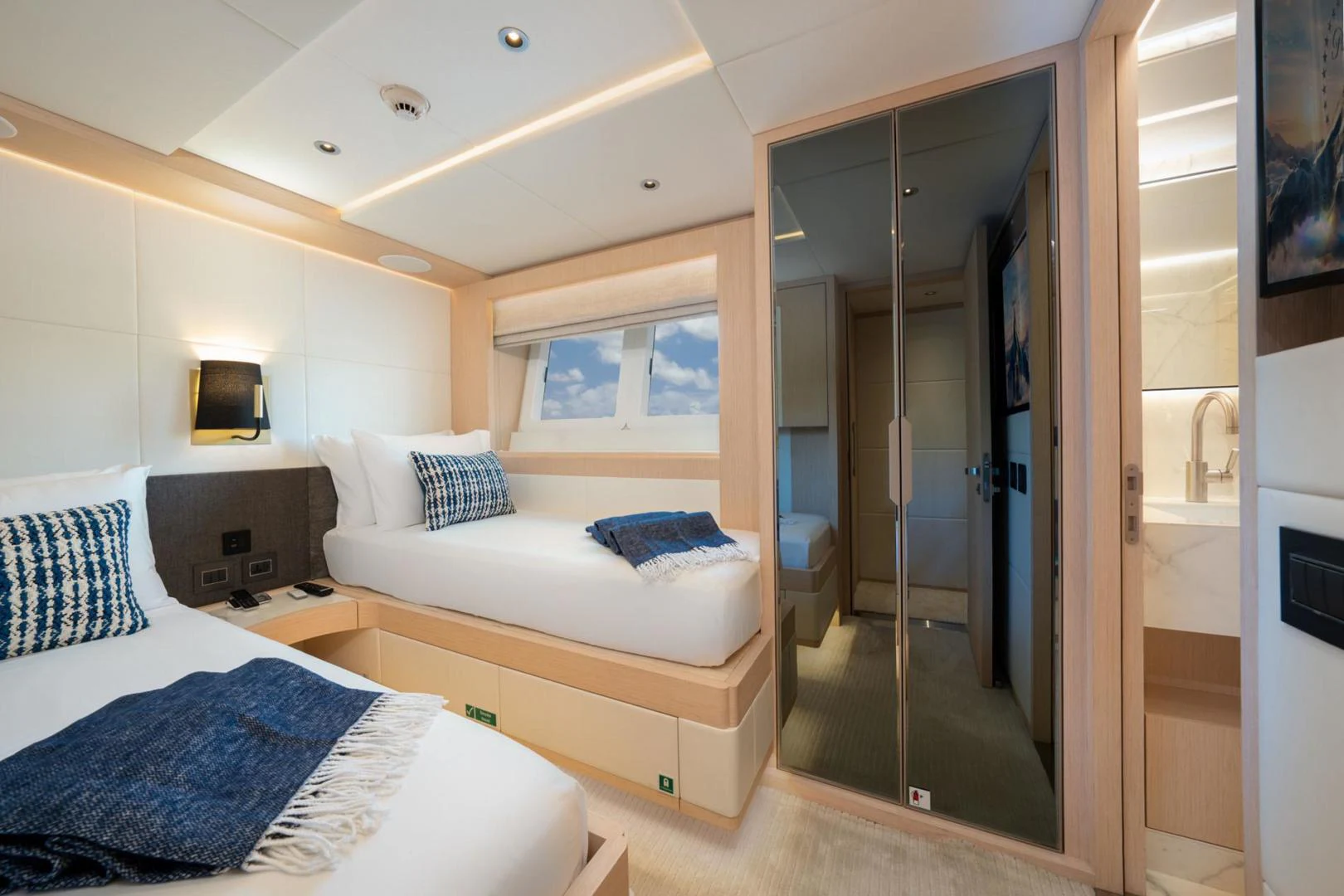 a bedroom with a glass door aboard SANTOSH Yacht for Sale