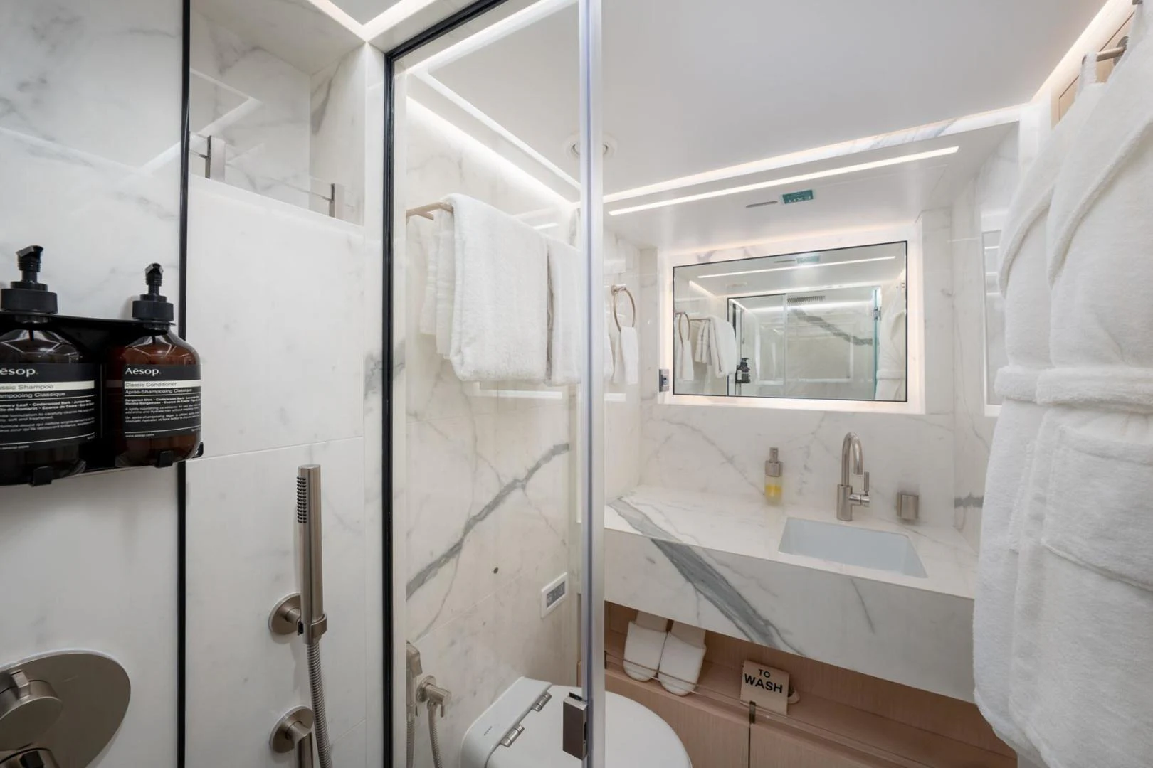 a bathroom with a glass shower aboard SANTOSH Yacht for Sale