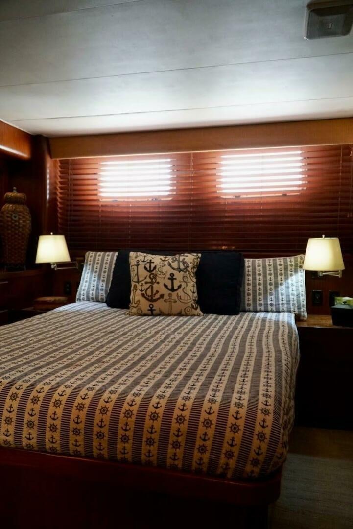 a bed with a blue and white bed spread aboard JOIE DE VIE Yacht for Sale