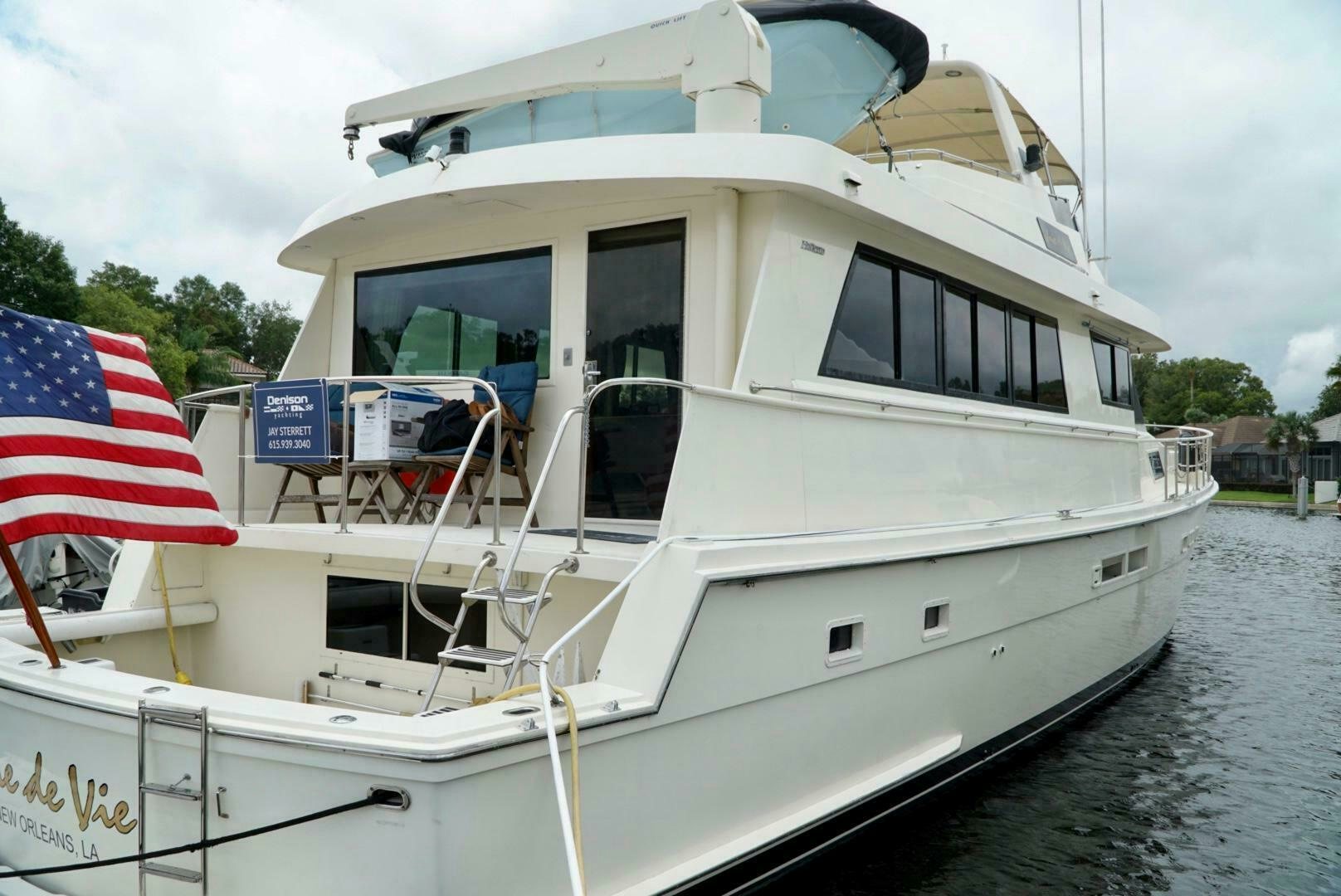 a boat with a flag on the deck aboard JOIE DE VIE Yacht for Sale