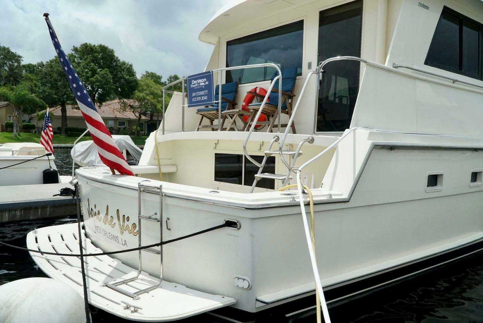 a boat with a flag on the front aboard JOIE DE VIE Yacht for Sale