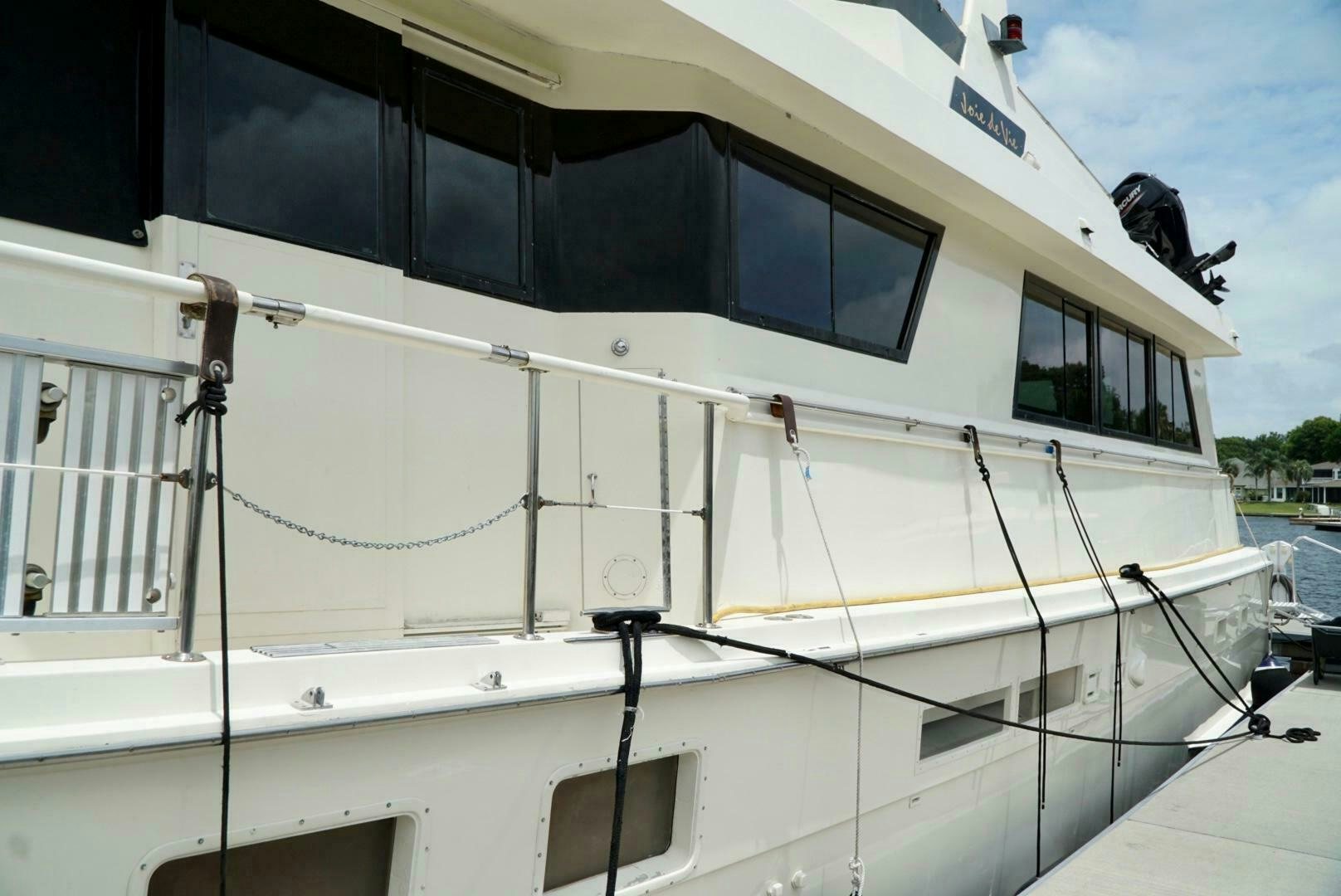 a white boat with a white stripe aboard JOIE DE VIE Yacht for Sale