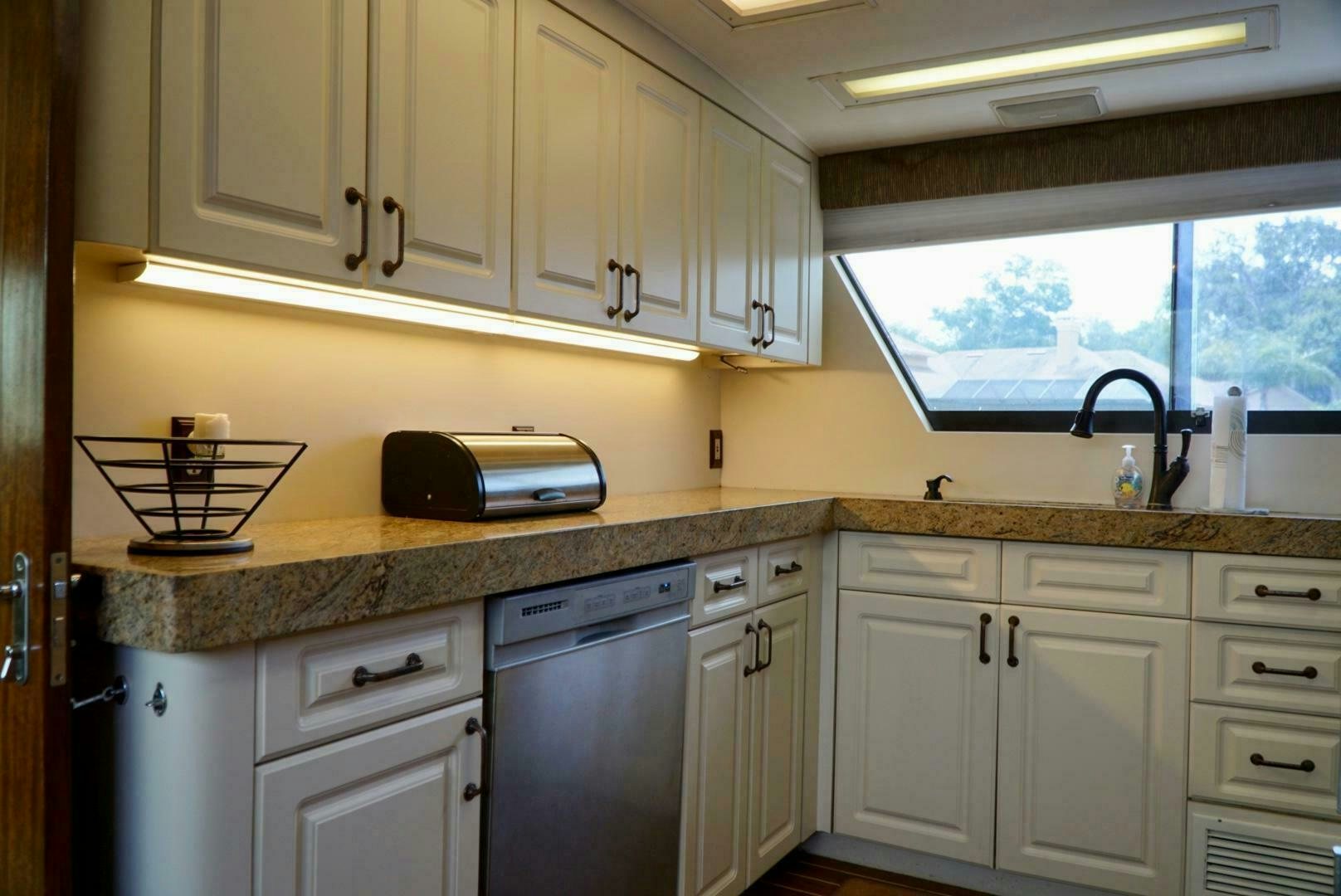 a kitchen with a microwave oven and a sink aboard JOIE DE VIE Yacht for Sale