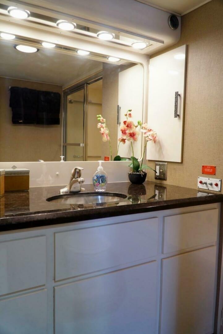 a bathroom with a sink and mirror aboard JOIE DE VIE Yacht for Sale