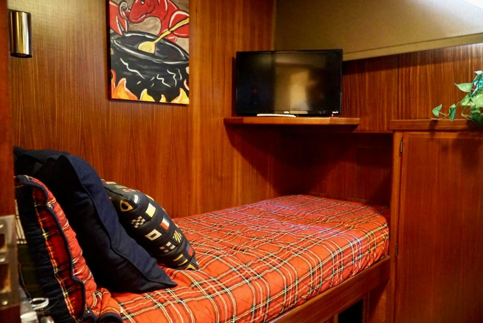 a bed with a red comforter aboard JOIE DE VIE Yacht for Sale