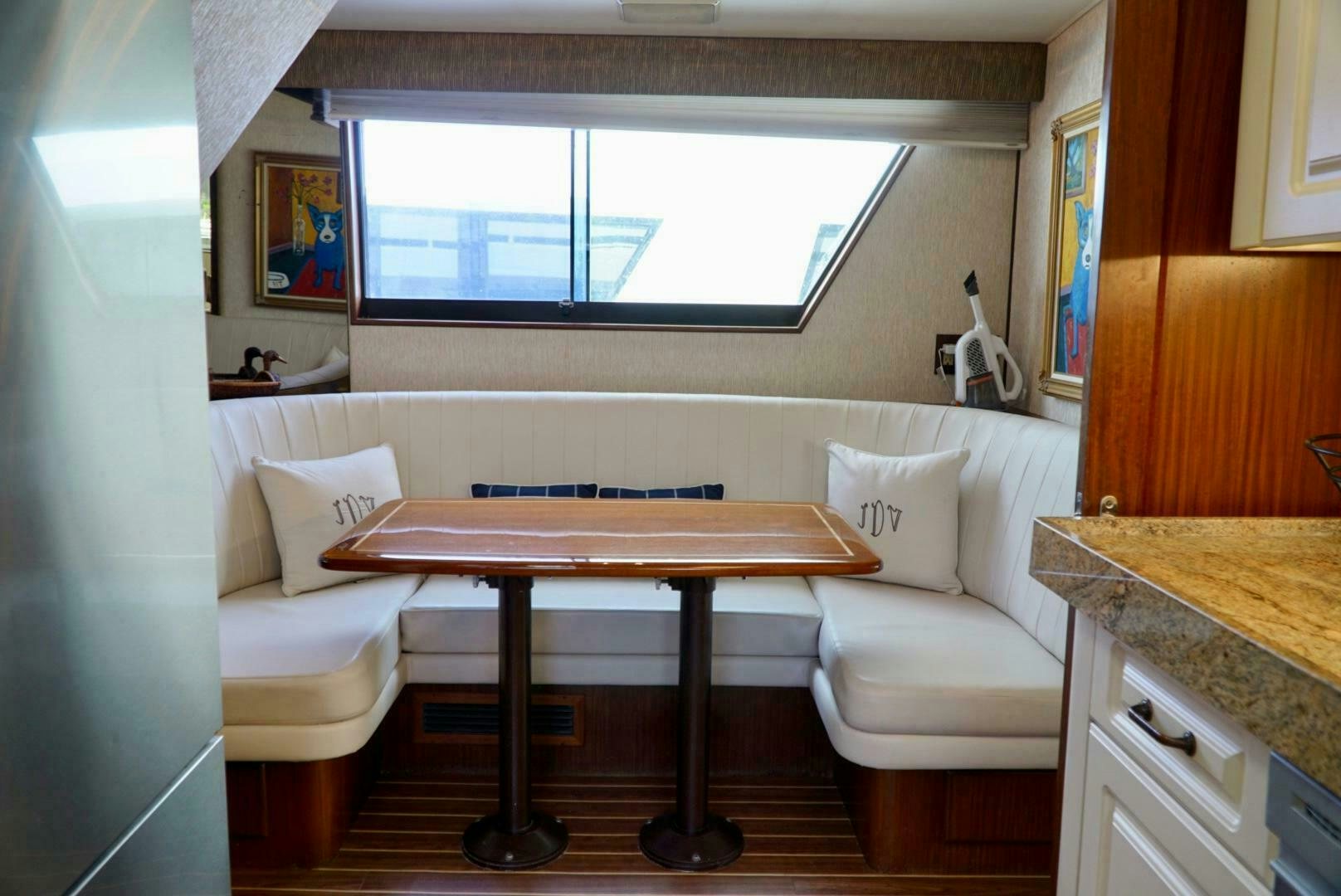 a living room with a table and a couch aboard JOIE DE VIE Yacht for Sale