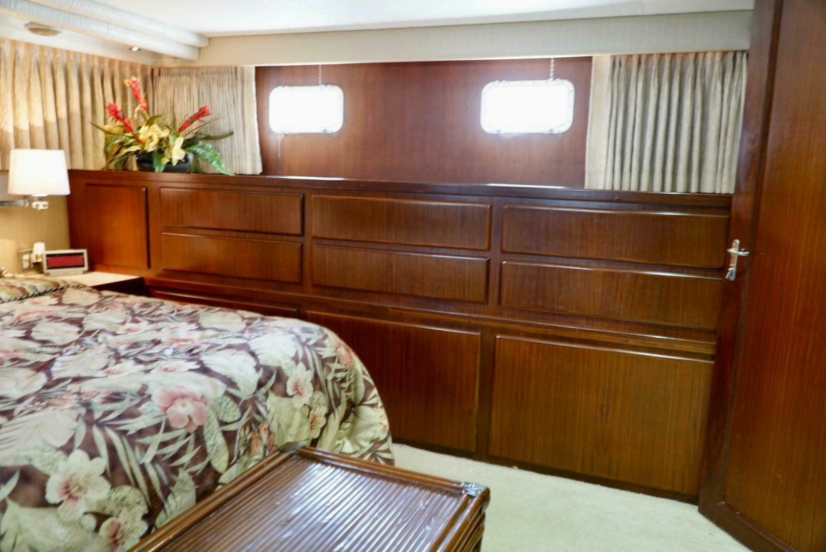 a room with a bed and a dresser aboard JOIE DE VIE Yacht for Sale