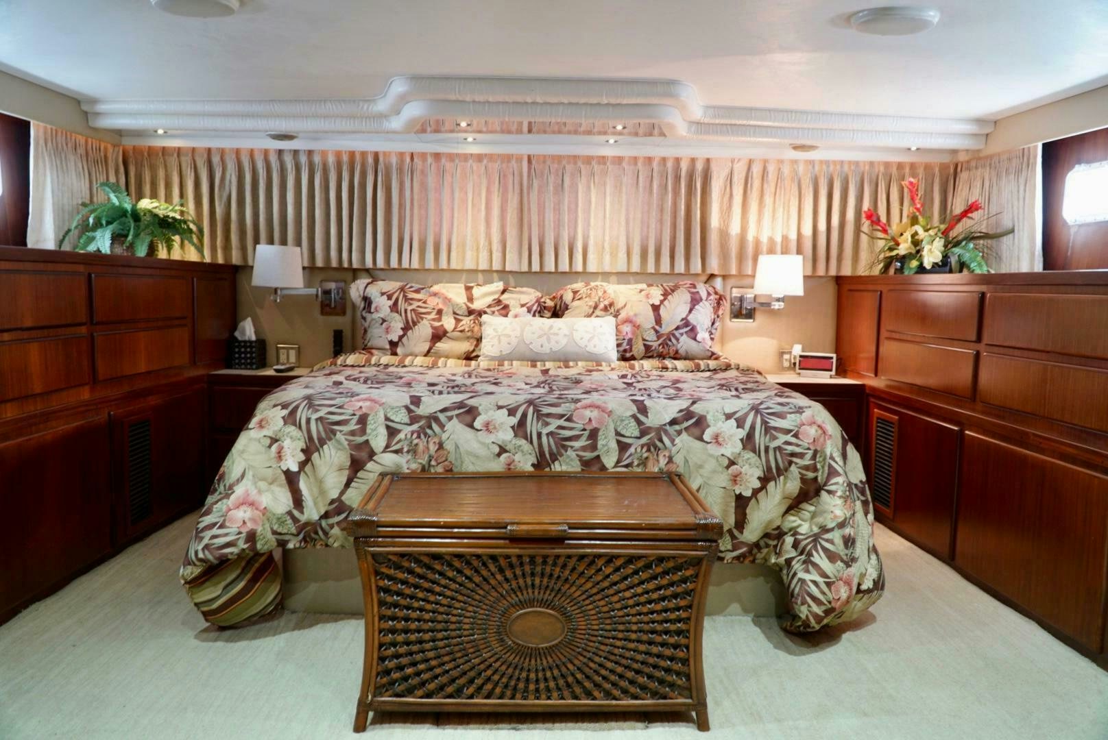 a bedroom with a bed and a dresser aboard JOIE DE VIE Yacht for Sale