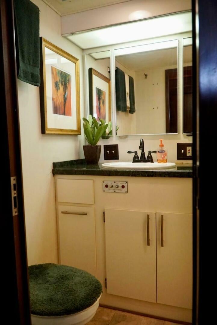 a bathroom with a sink and a mirror aboard JOIE DE VIE Yacht for Sale