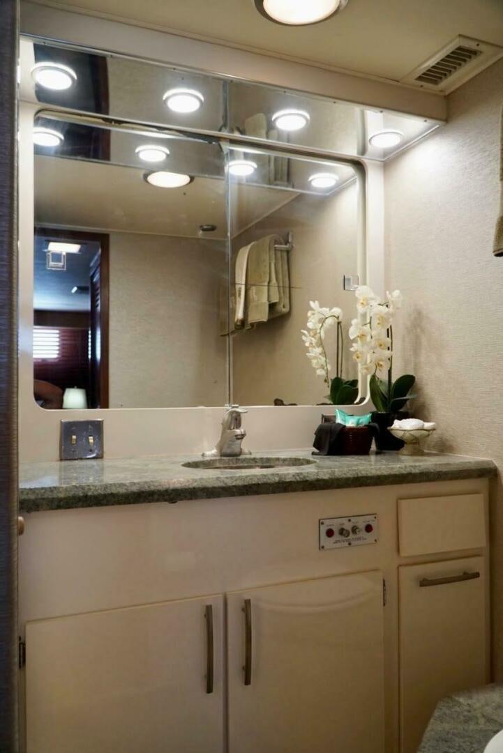 a bathroom with a large mirror aboard JOIE DE VIE Yacht for Sale