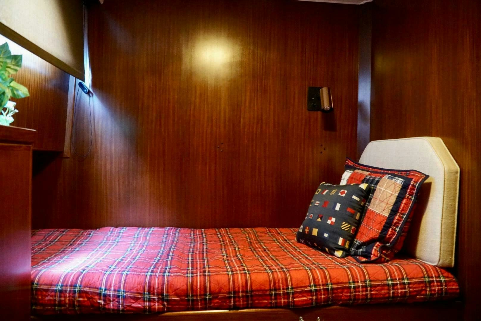 a bed with a plaid sheet aboard JOIE DE VIE Yacht for Sale