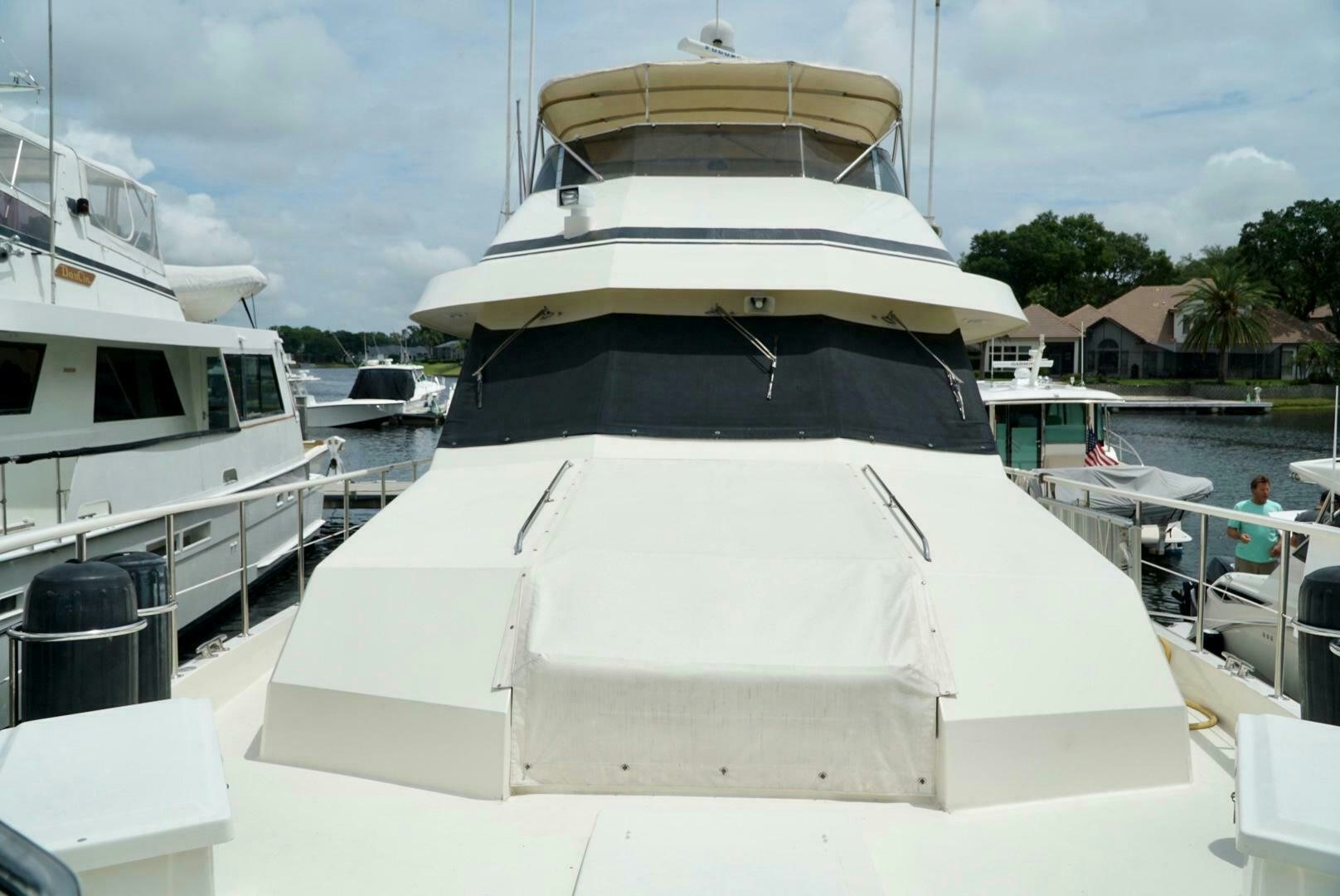 a large white boat in a harbor aboard JOIE DE VIE Yacht for Sale