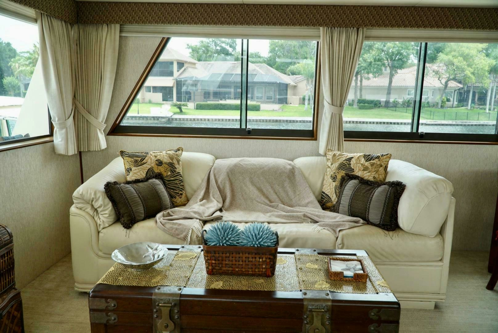 a living room with a couch and a coffee table aboard JOIE DE VIE Yacht for Sale