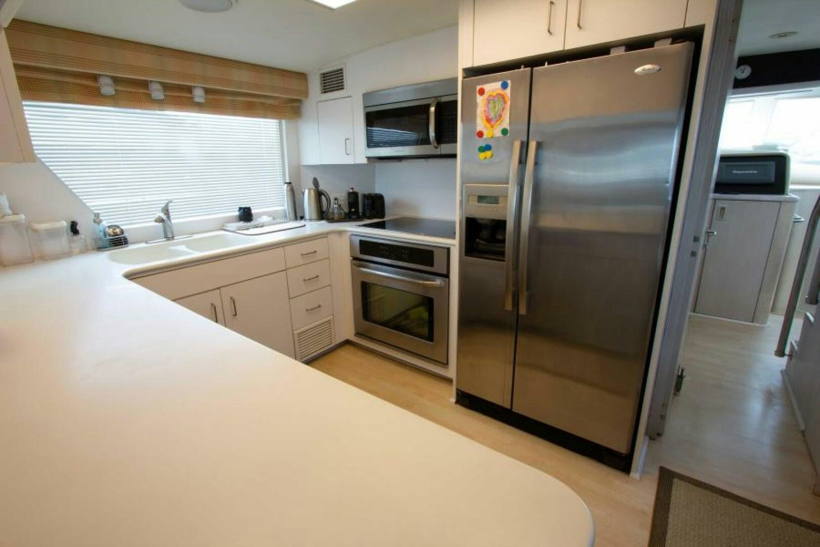 a kitchen with a stainless steel refrigerator aboard FULL MOON Yacht for Sale