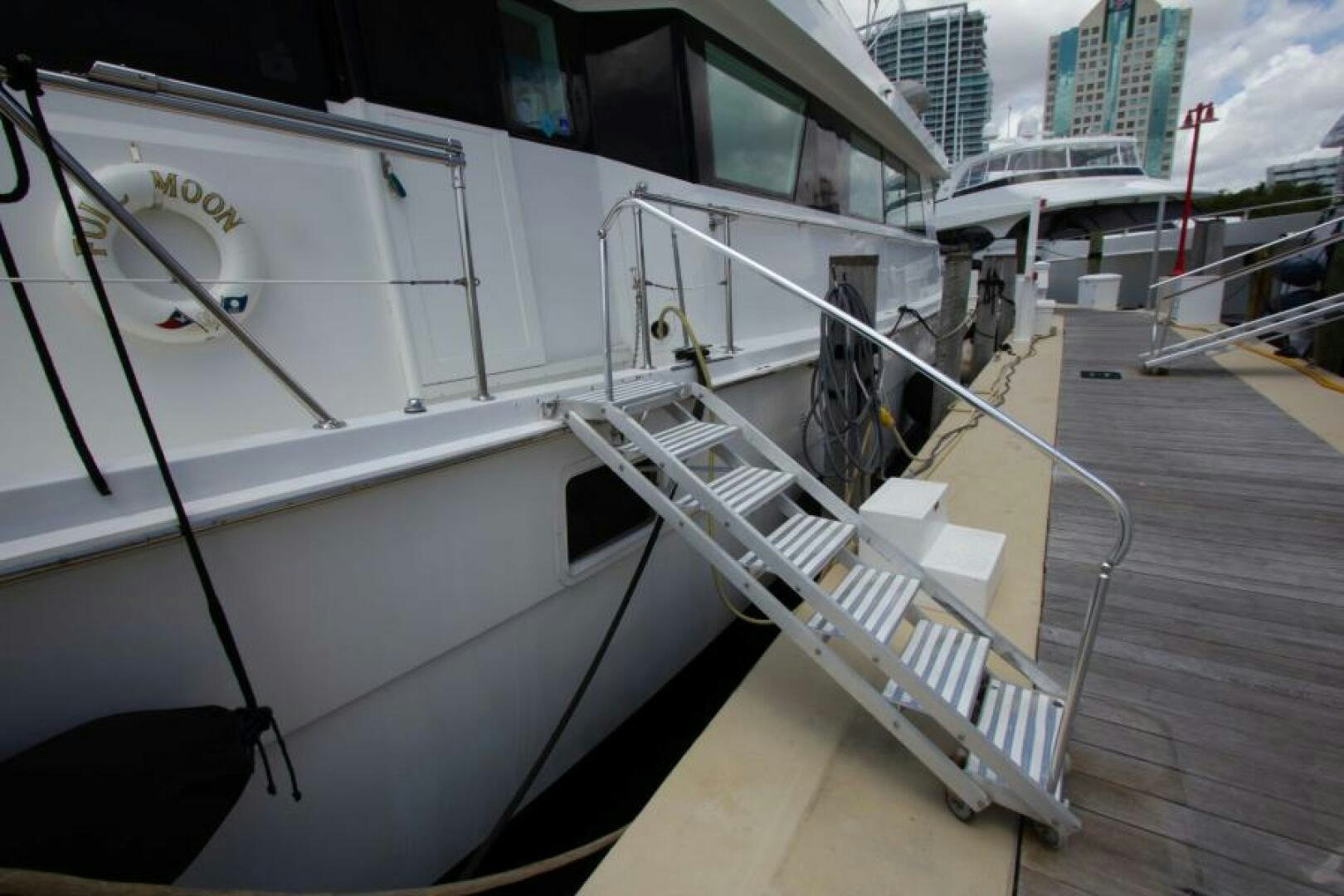 a white boat on a dock aboard FULL MOON Yacht for Sale