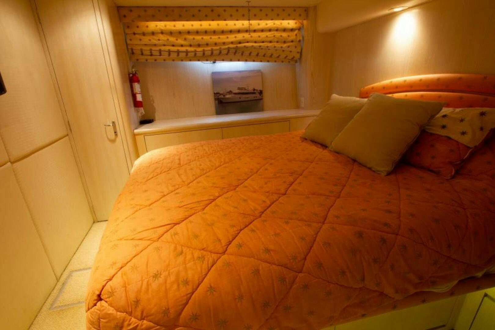 a bed with orange sheets aboard FULL MOON Yacht for Sale